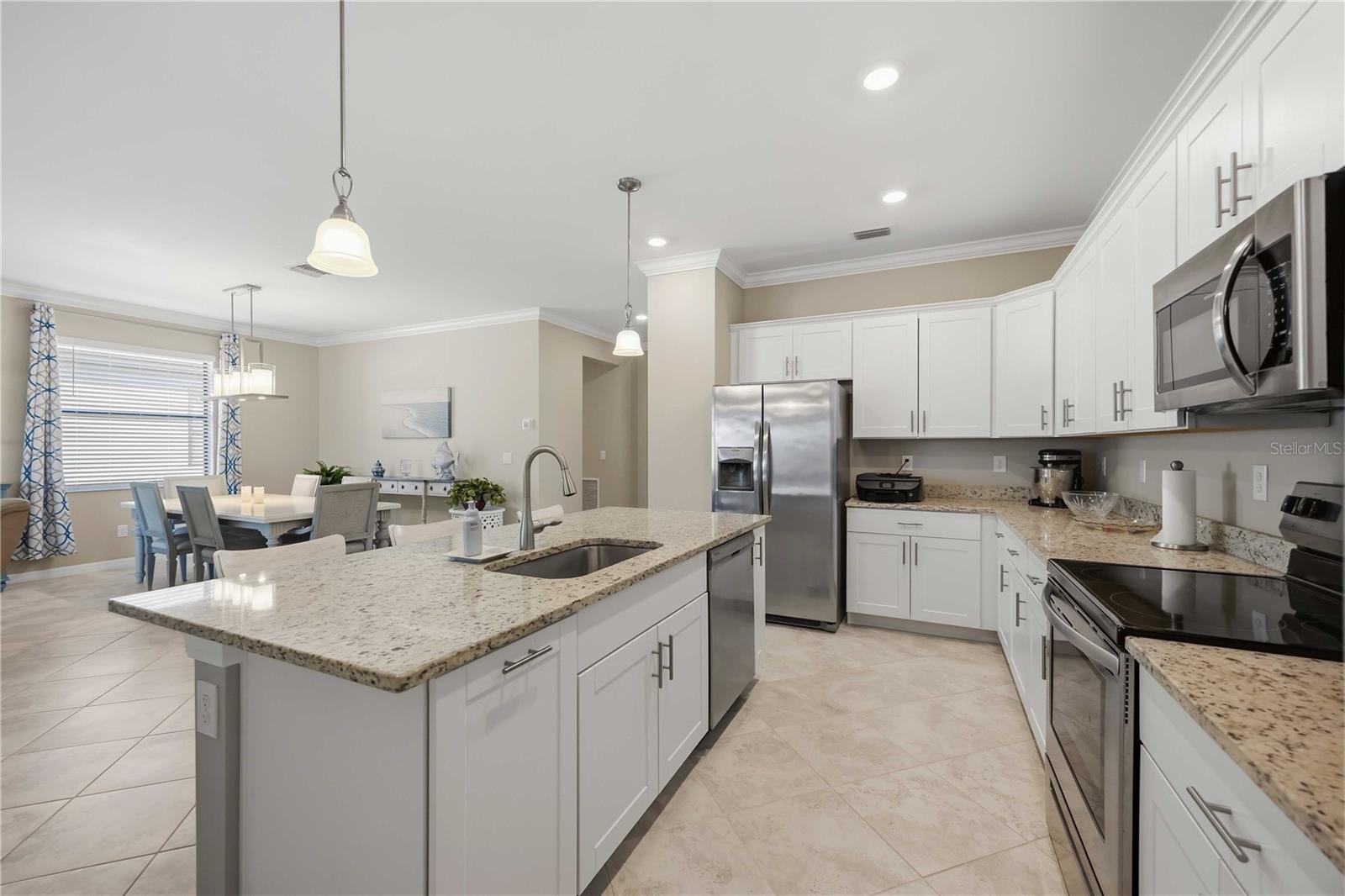Granite counters, stainless steel appliances and white shaker cabinetry