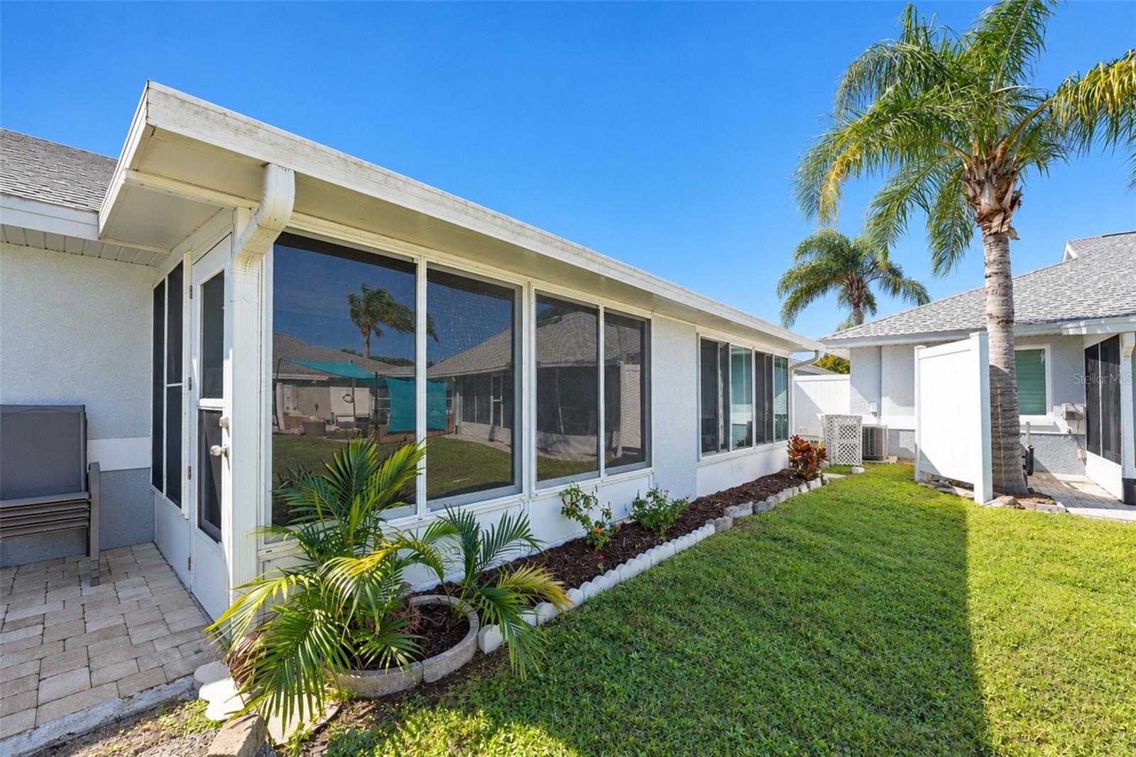 The GLASS-ENCLOSED Florida room is a great extension of your living space!
