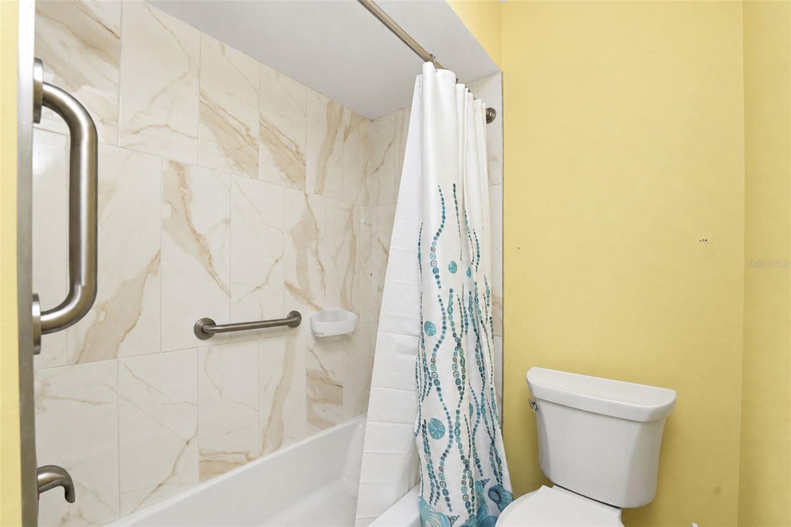 The guest bathroom features a tub/shower combo with a new tub & new wall tile.
