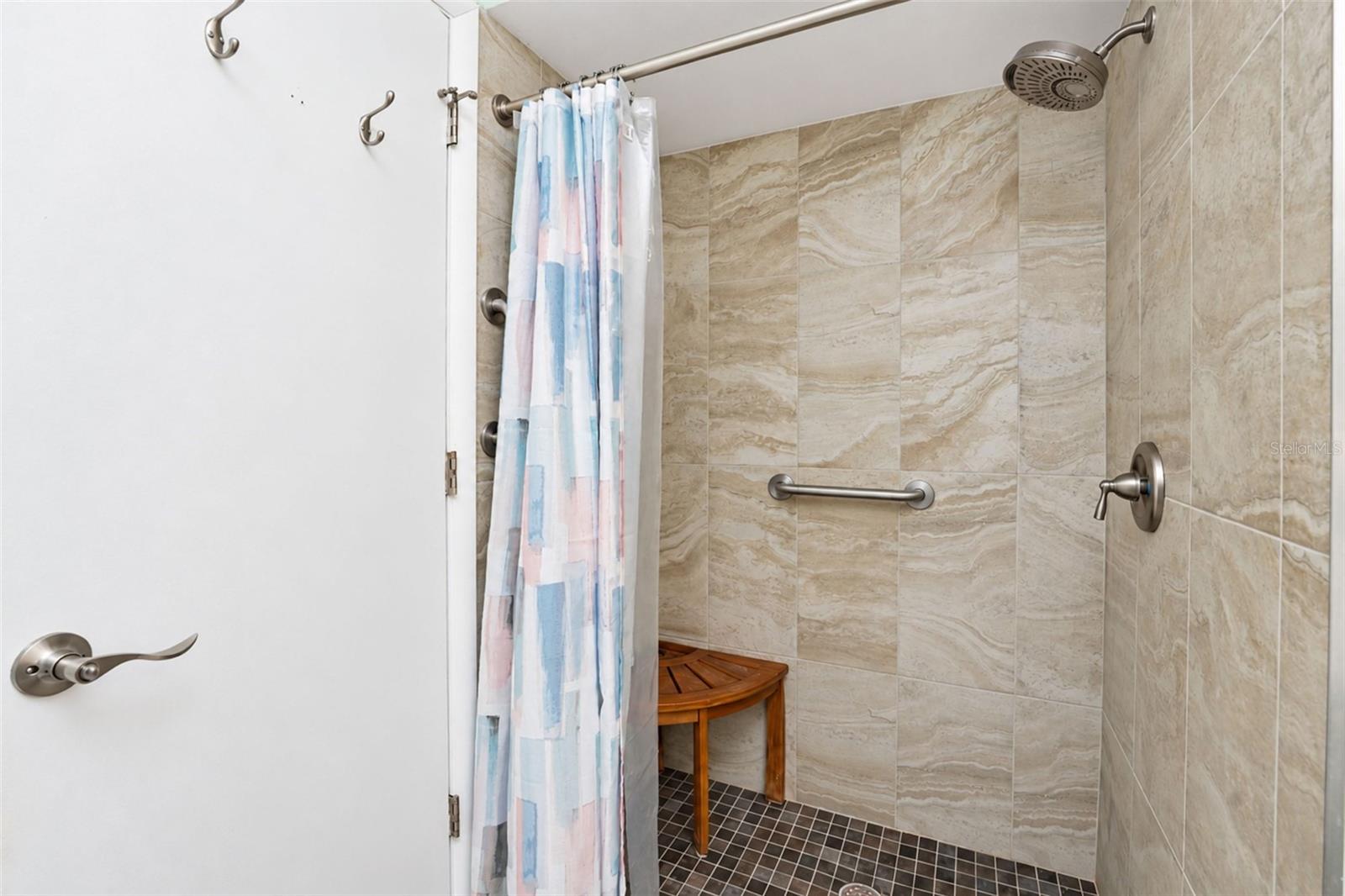 The ensuite bathroom has a step-in shower with new tile.