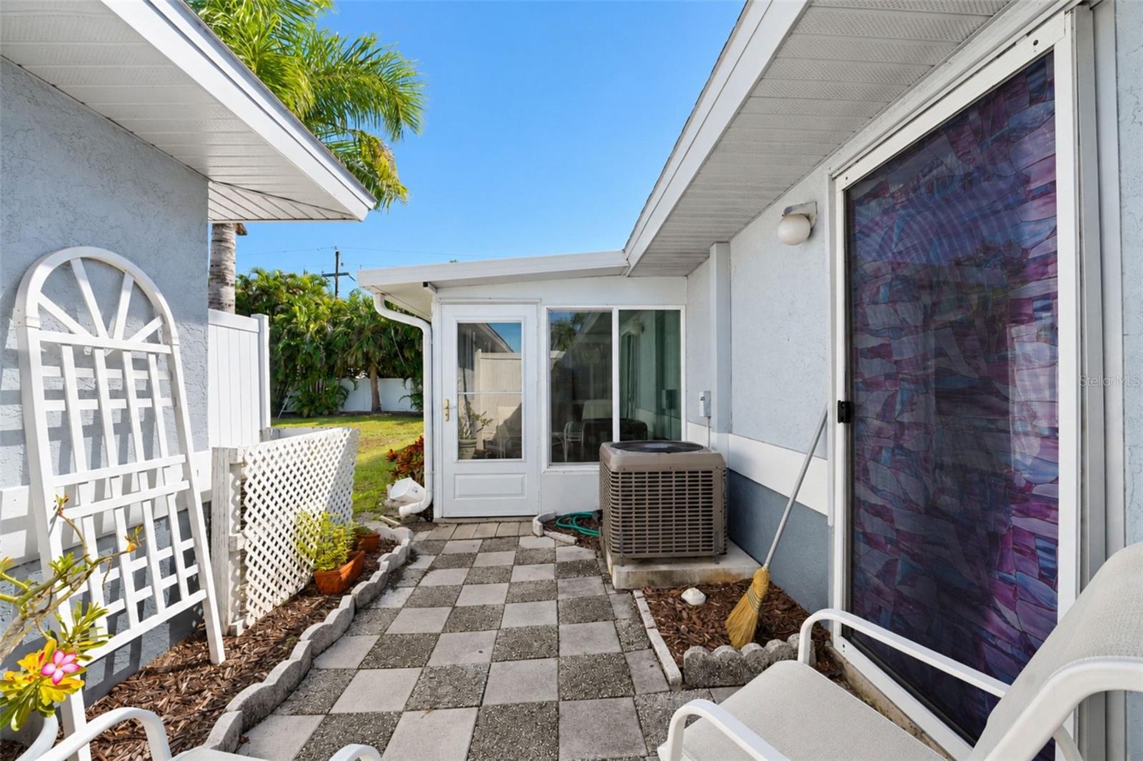 The rear patio has access from the primary bedroom and Florida room.