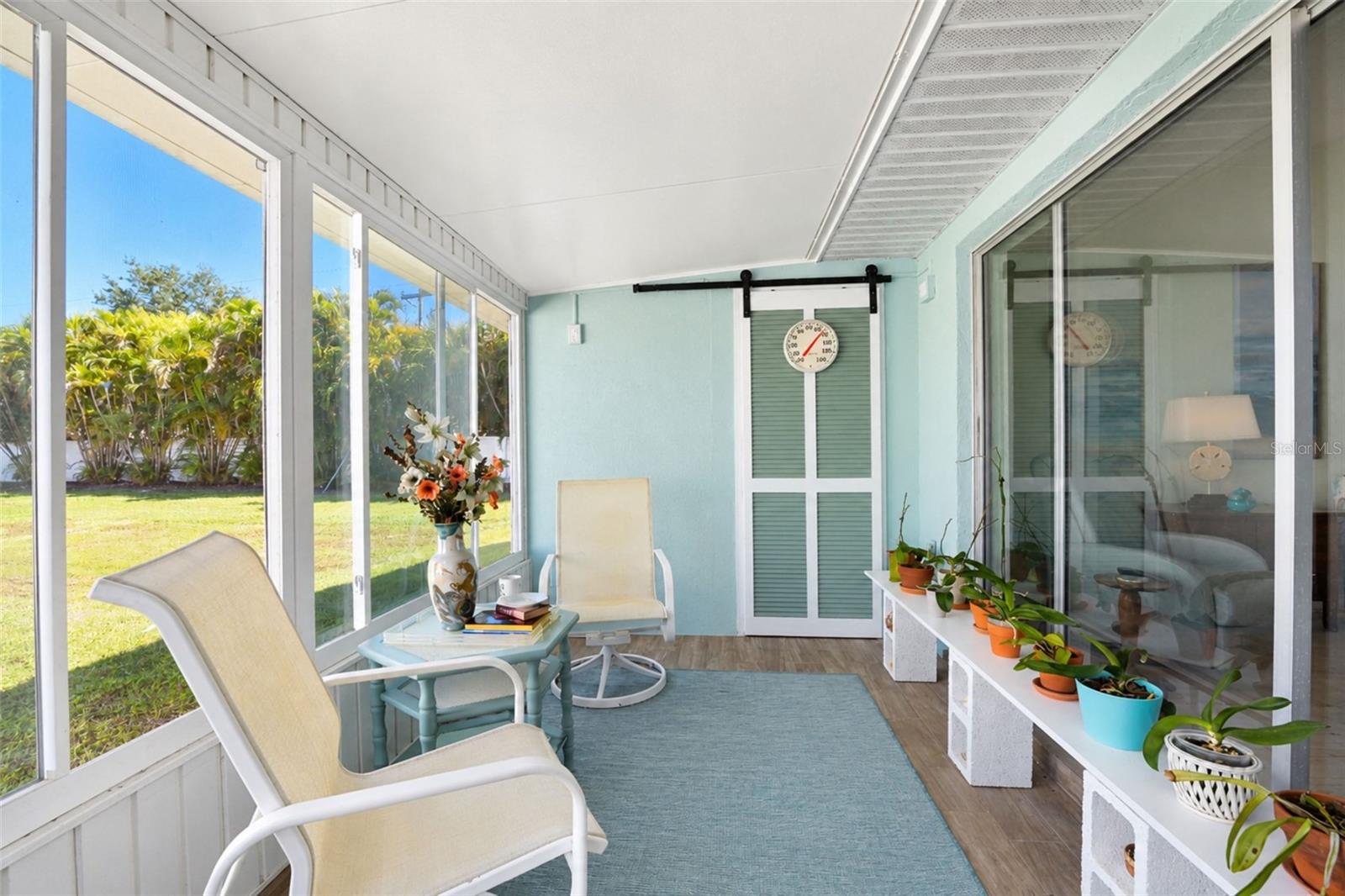 The GLASS-ENCLOSED Florida room lets you enjoy the outdoors no matter what the weather or temperature is!