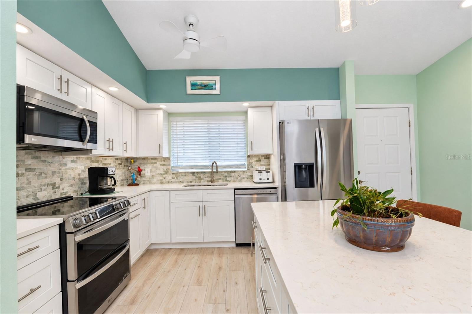 The gorgeous kitchen features an all stainless steel LG appliance package including a French door refrigerator, dishwasher, microwave and range with double ovens & a built-in air fryer. The gorgeous kitchen features an all stainless steel LG appliance package including a French door refrigerator, dishwasher, microwave and range with double ovens & a built-in air fryer.