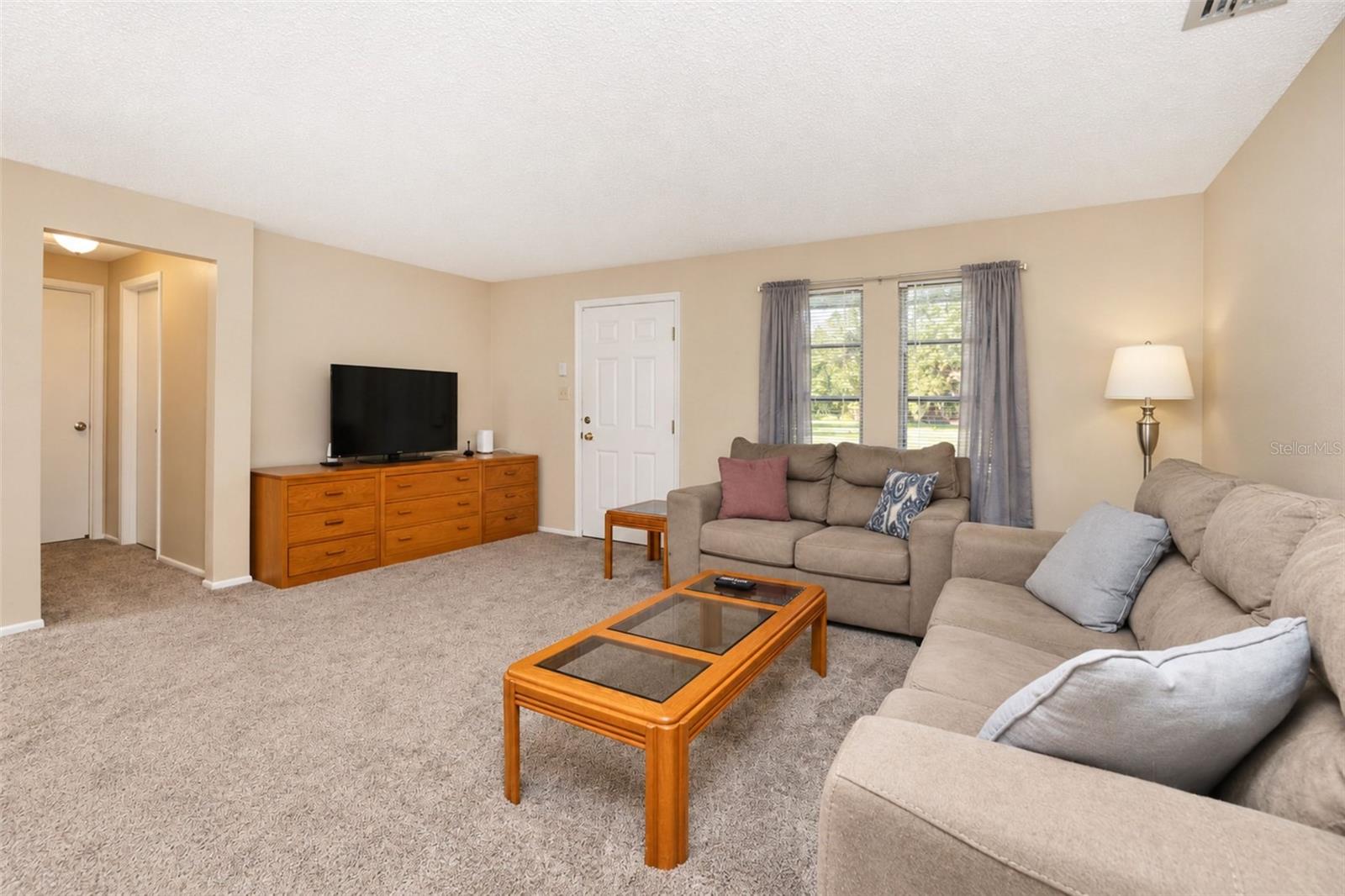 Living room leads to primary bedroom suite