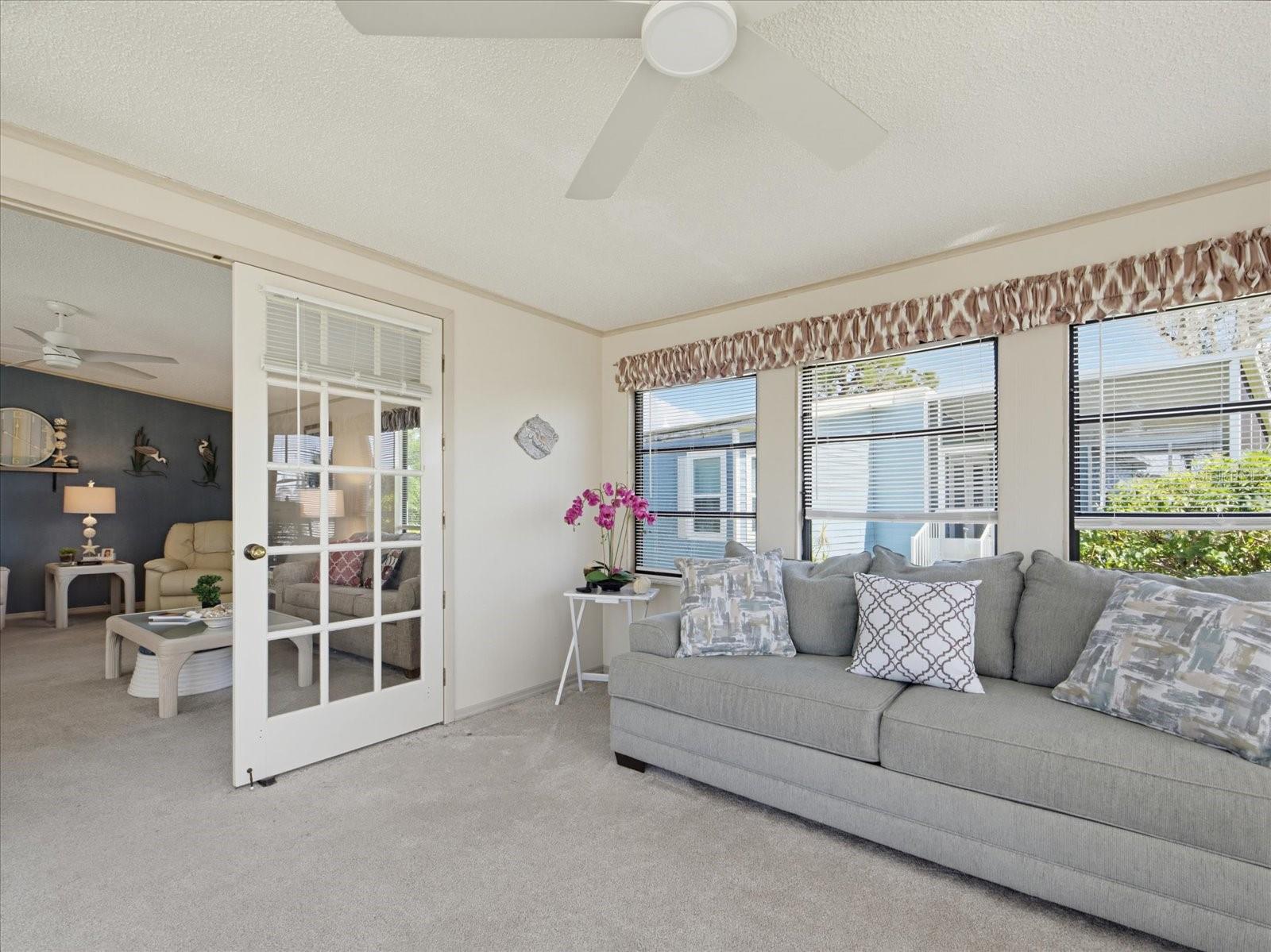 FRENCH DOORS LEAD TO THE LIVING ROOM.