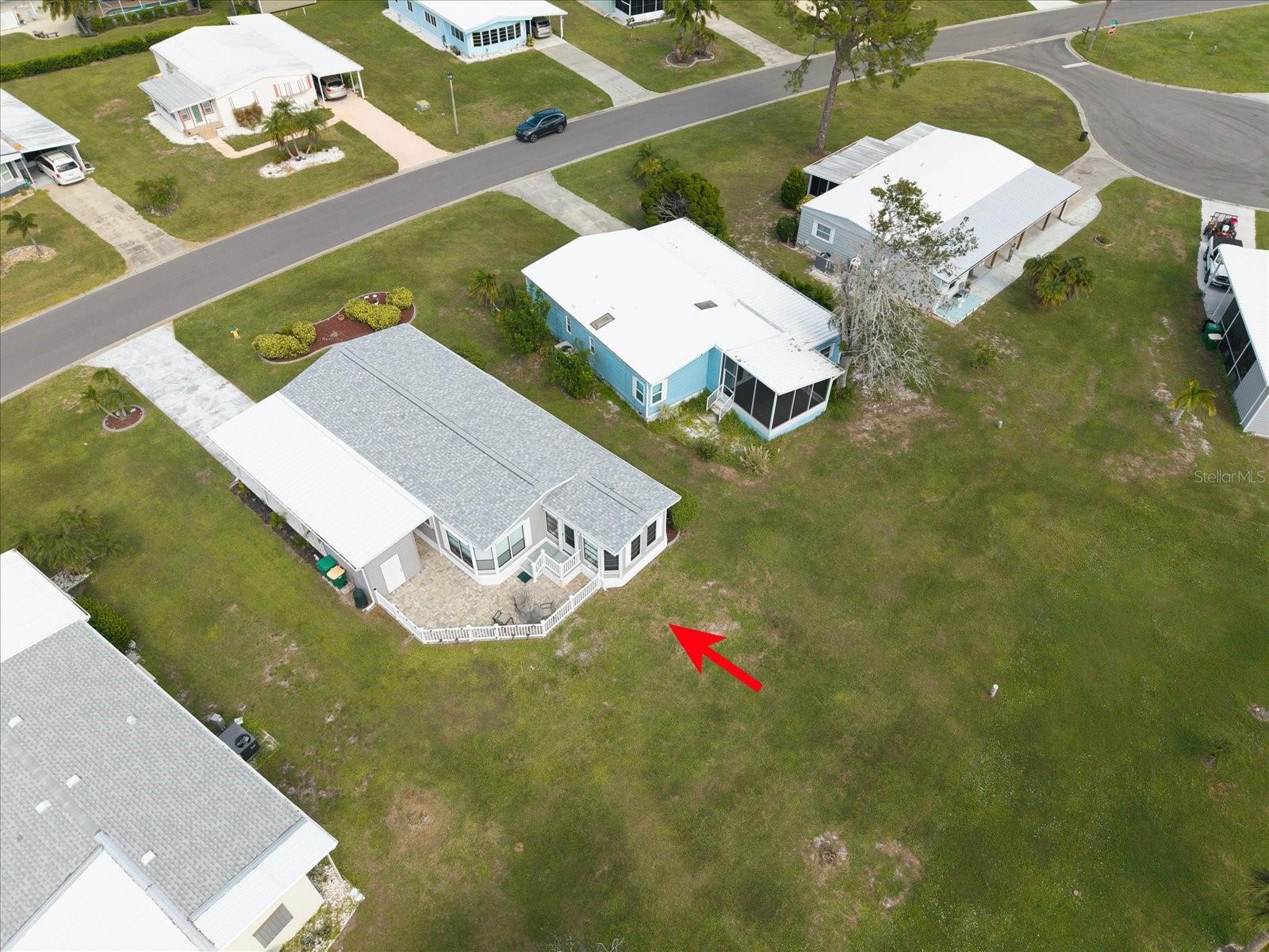 OVERAL AERIAL VIEW OF THE PROPERTY AND POND. ROOF REPLACED 2024.