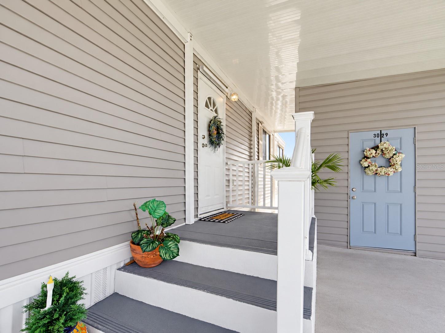 STEPPING BACK OUTSIDE. THE FRONT ENTRANCE IS COVERED. PLUS A NICE SIZE STORAGE BUIDLING.