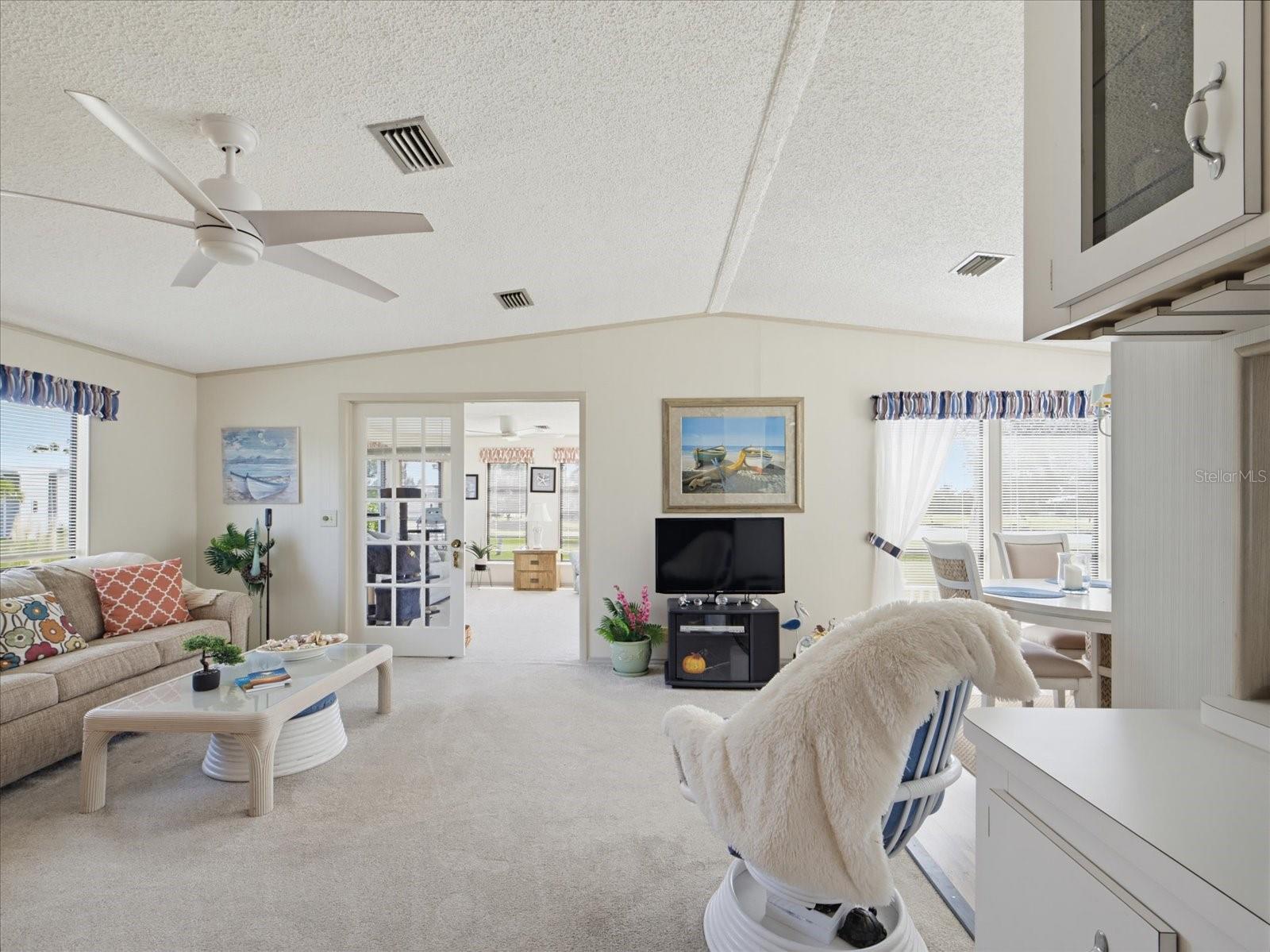 LIVING ROOM HAS A VAULTED CEILING. FRENCH DOORS LEAD TO THE FLORIDA ROOM. LIVING ROOM HAS A VAULTED CEILING. FRENCH DOORS LEAD TO THE FLORIDA ROOM.