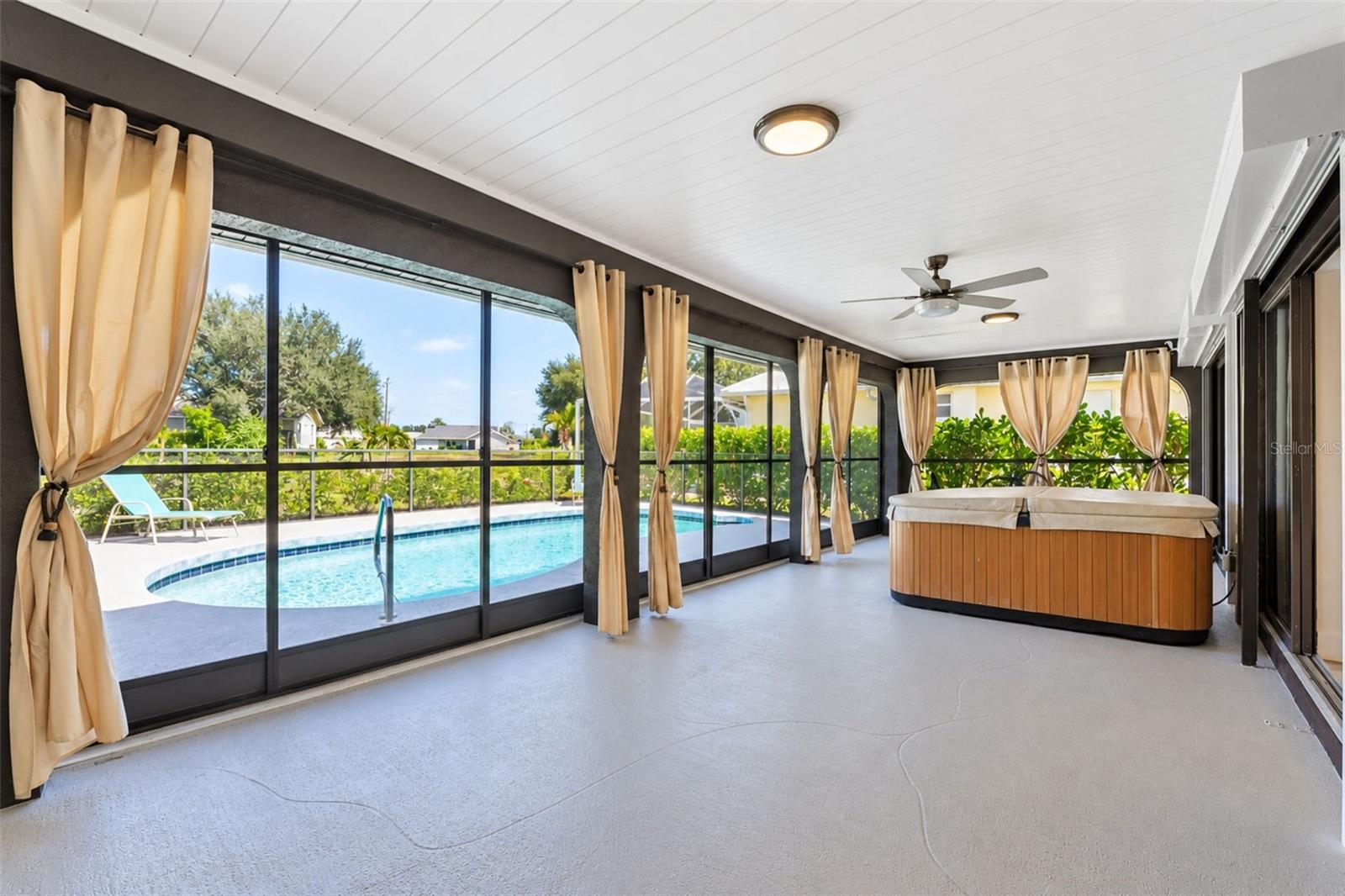 Covered and screened lanai overlooking the pool and golf course.