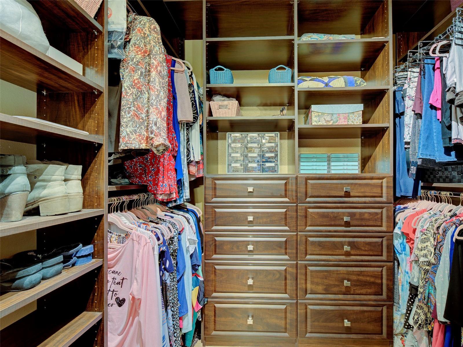 Primary walk-in with custom closet system.
