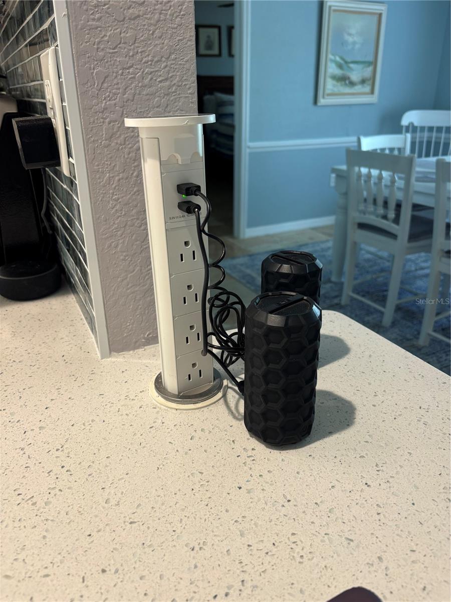 Pop up power bar and charger in kitchen counter folds away