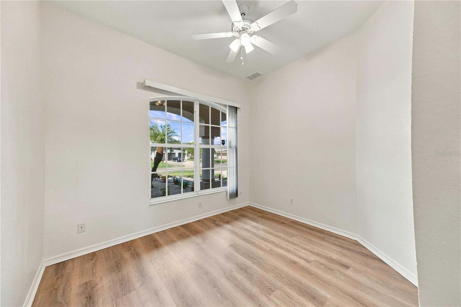Bedroom with ceiling fan and natural light