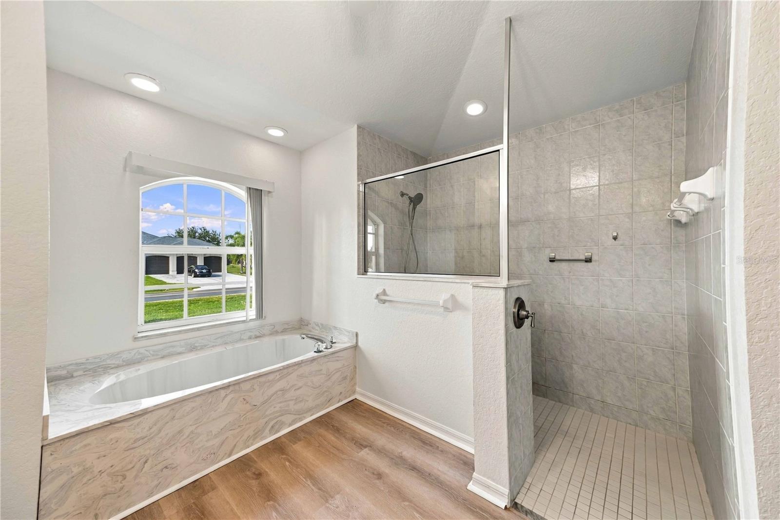 Primary bathroom with walk-in shower and soaking tub