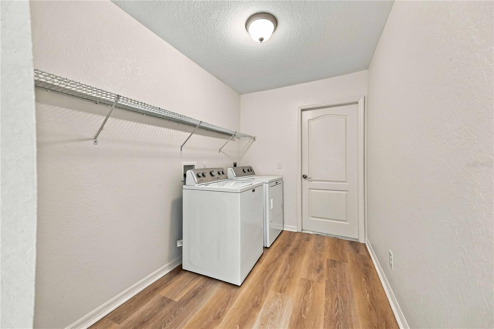 Inside laundry room with washer and dryer