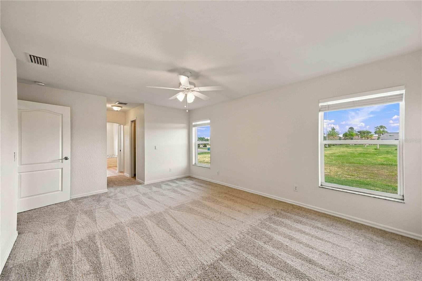 Primary bedroom with views of the yard