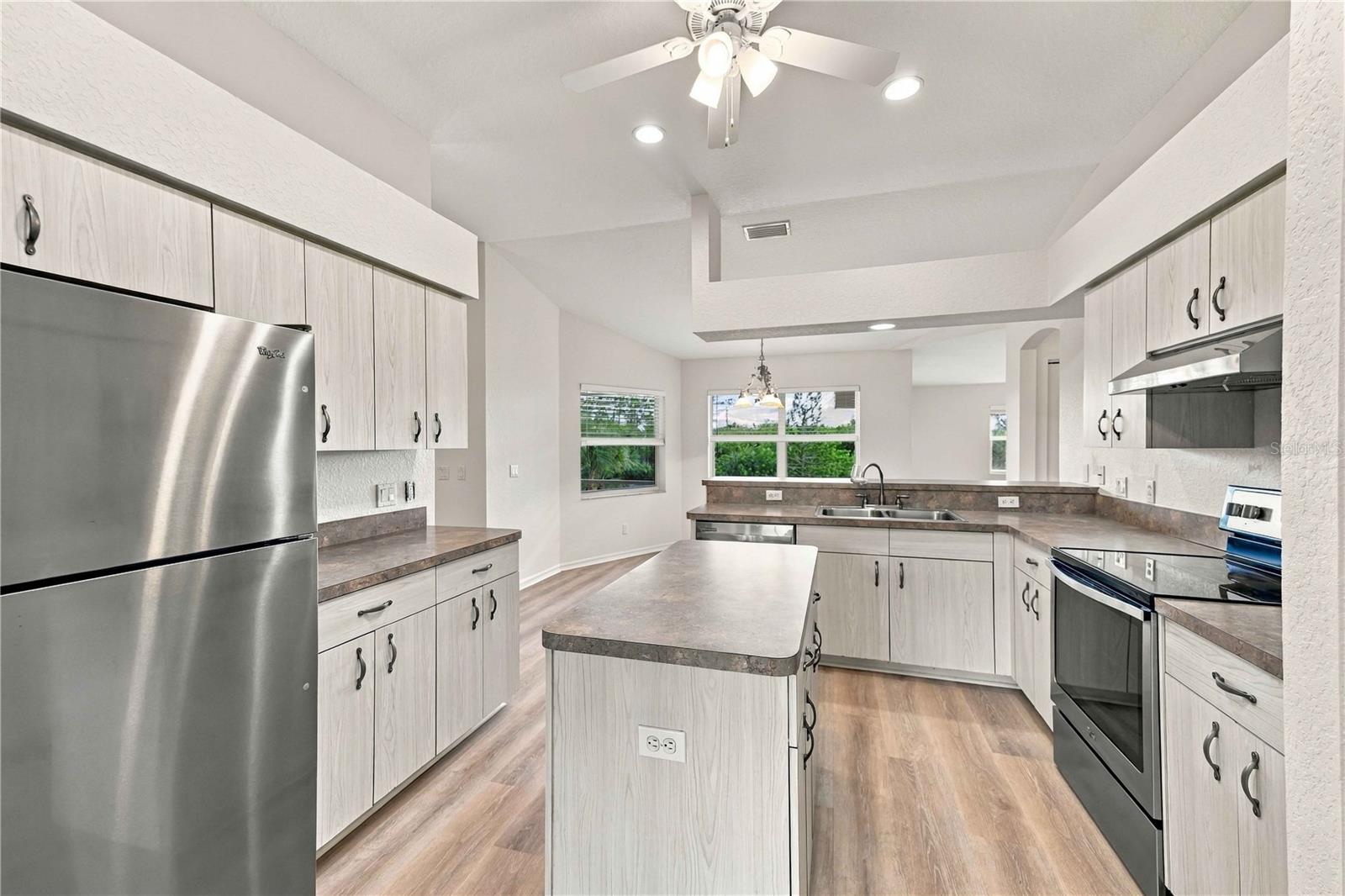 Kitchen with stainless refrigerator and ample cabinetry