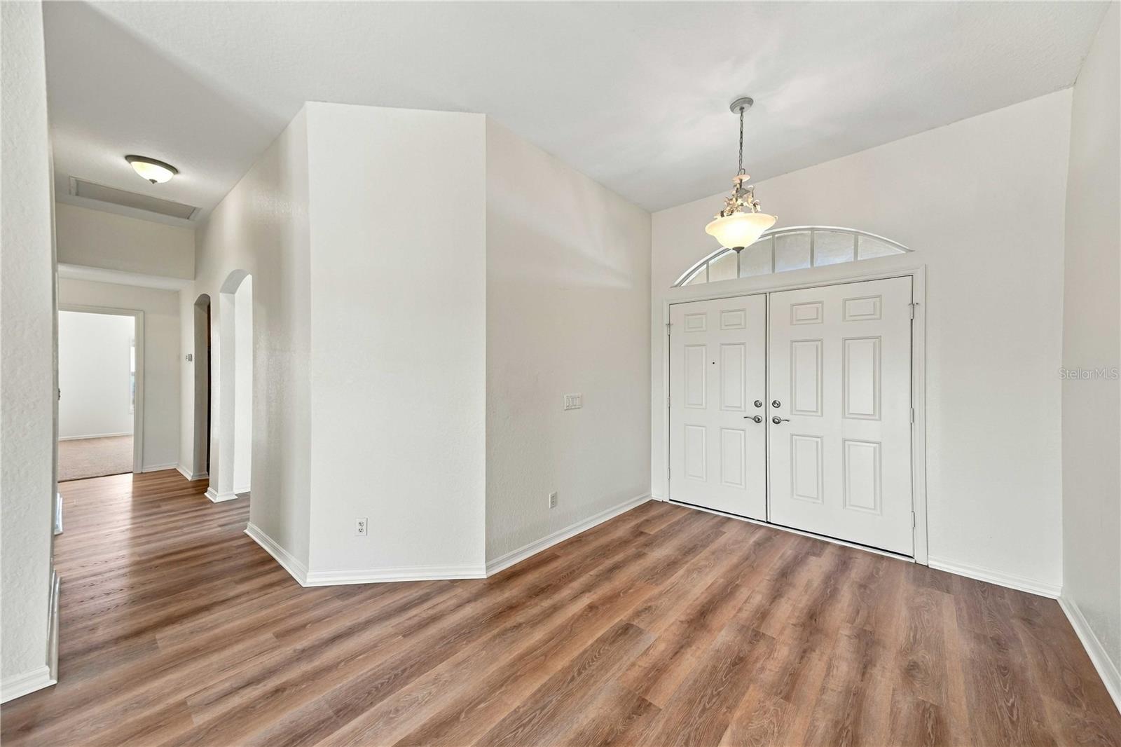 Foyer area with pendant lighting