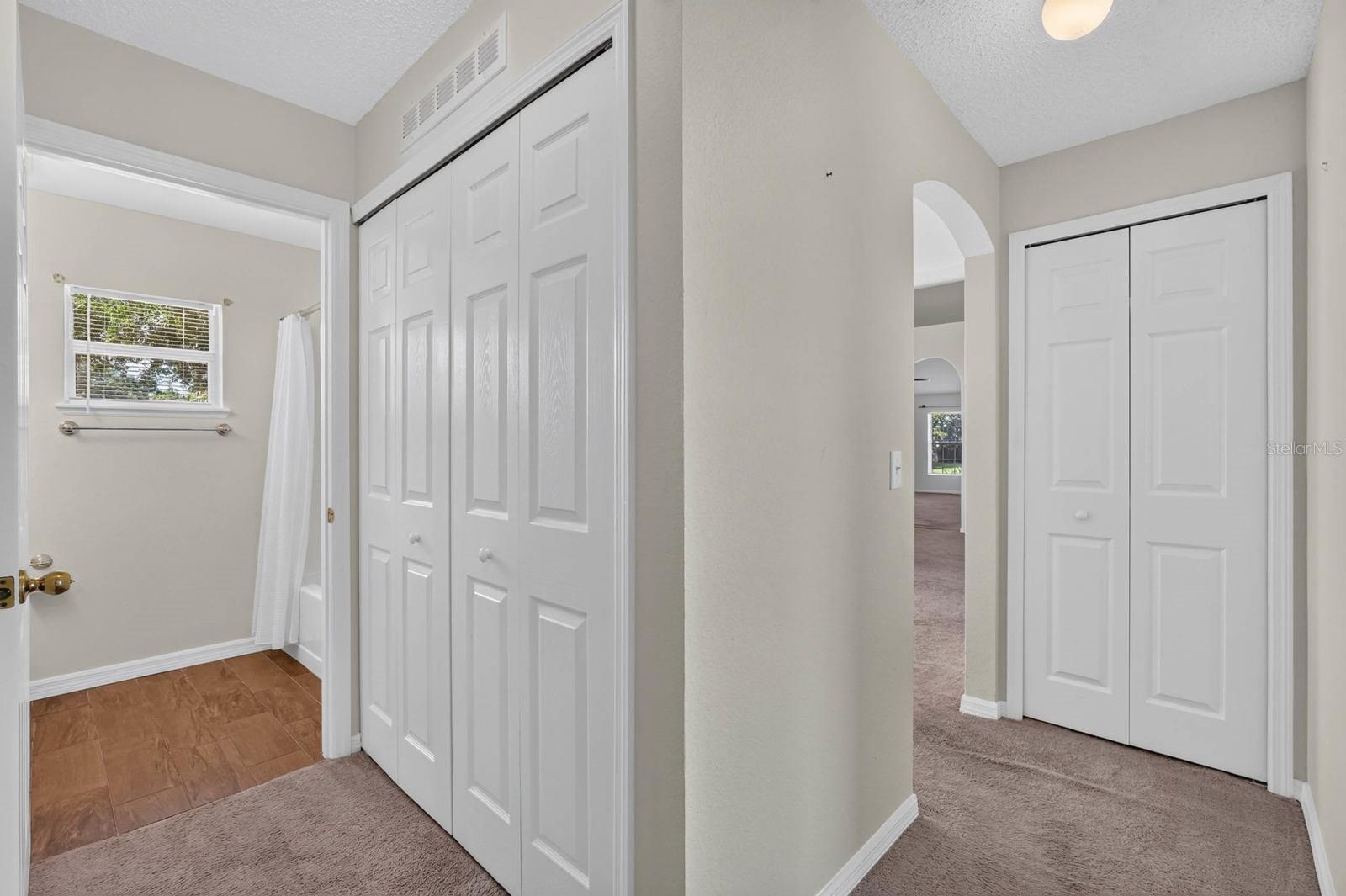 guest hallway with laundry closet and to the right down the hall the linen closet