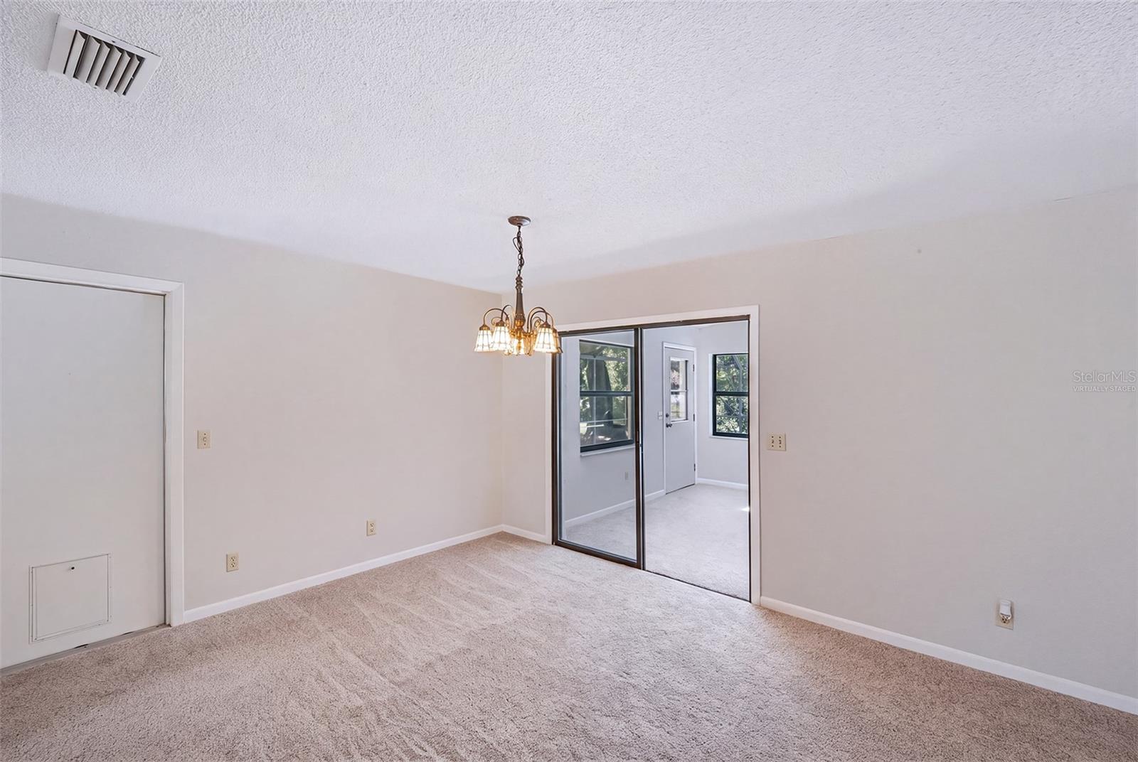 Virtually staged empty dinette adjacent to Florida room