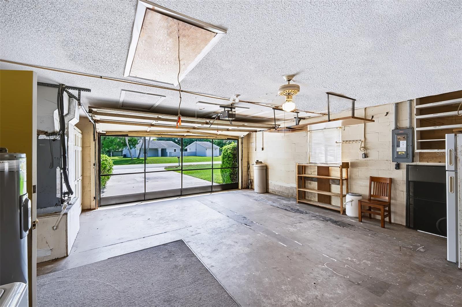 View of garage exiting door from dinette area. This shows the sliding screen doors in use with the garage door open