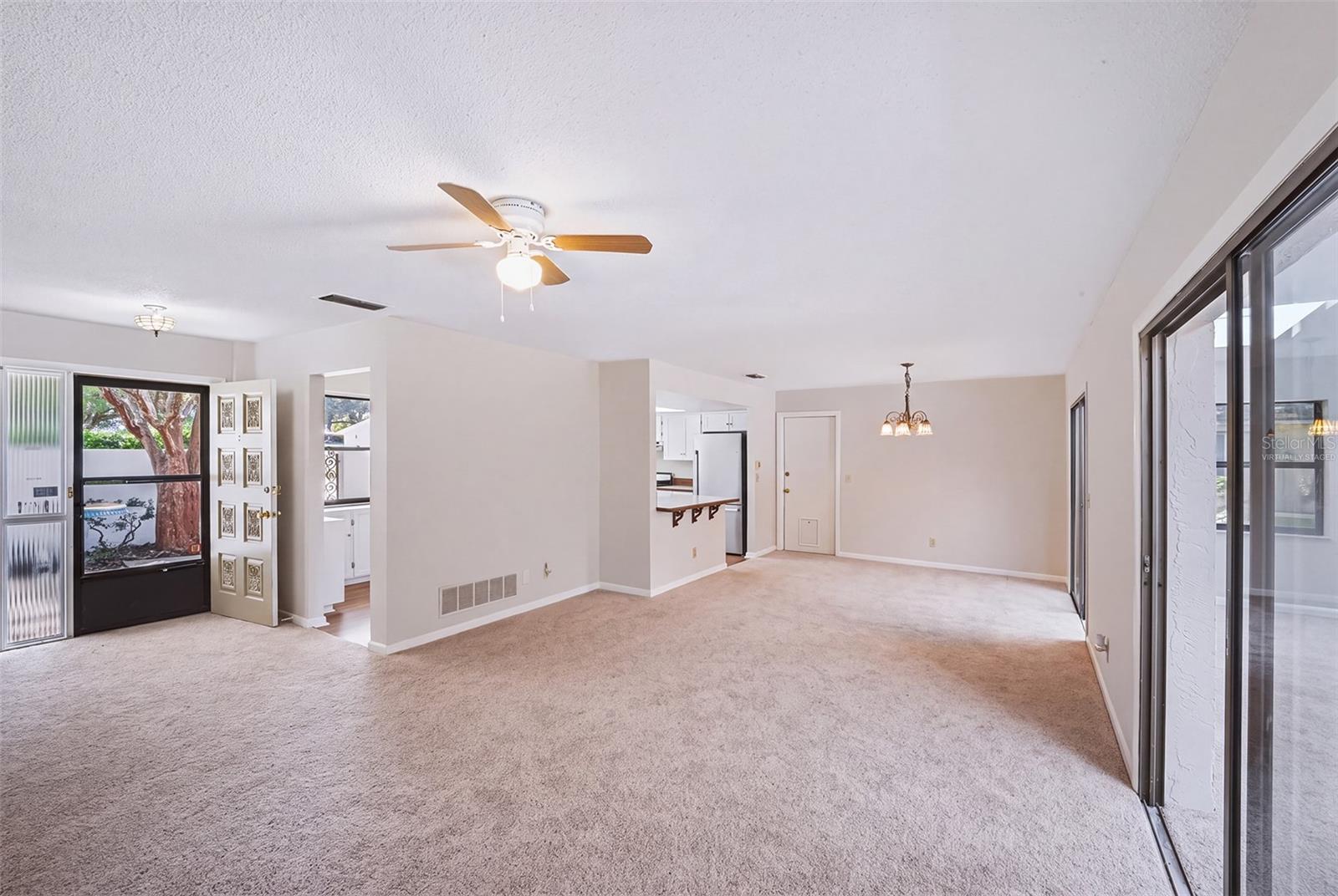 Virtually staged empty living room/dinette area