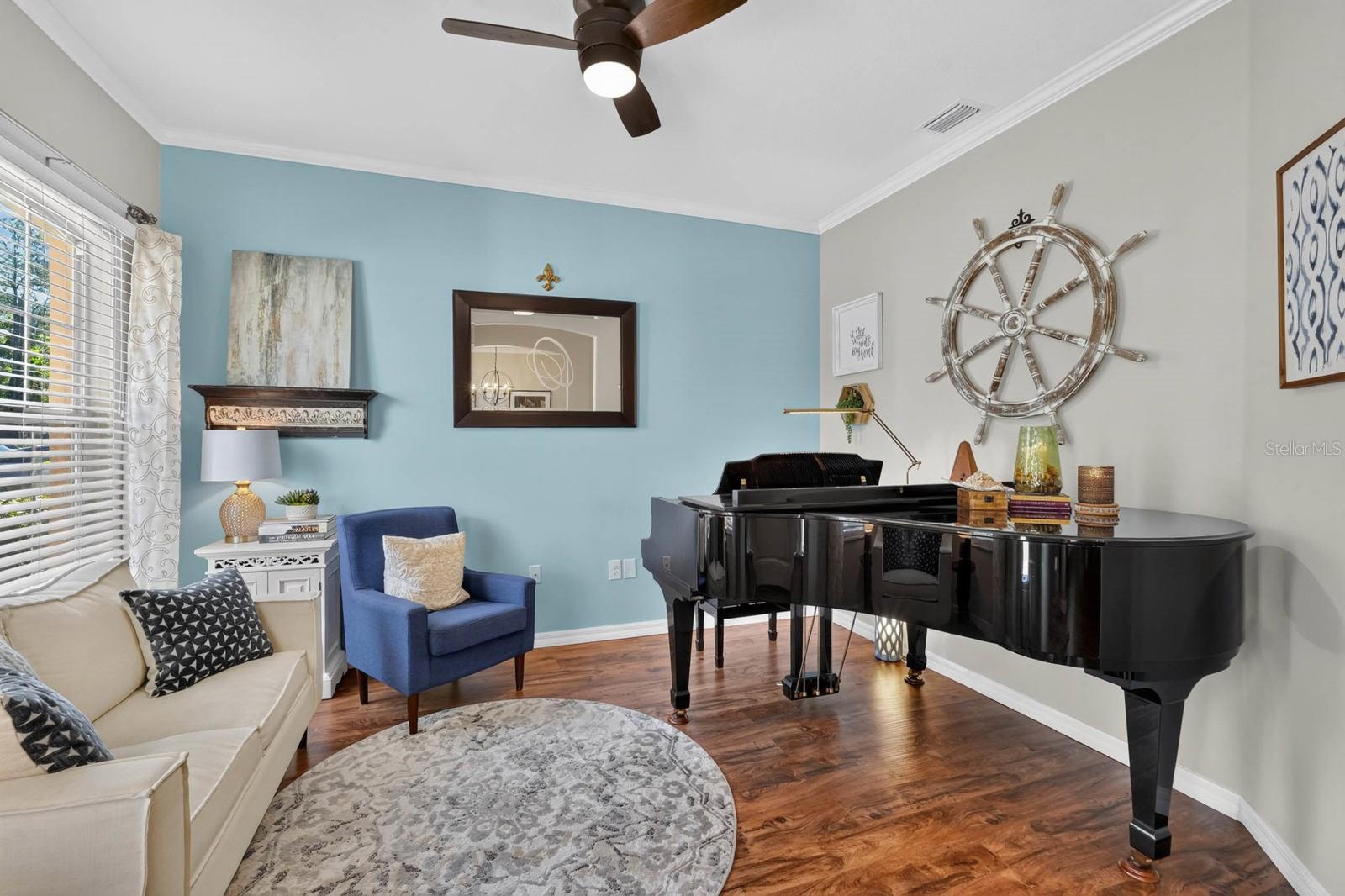 Den, office or living room with crown molding