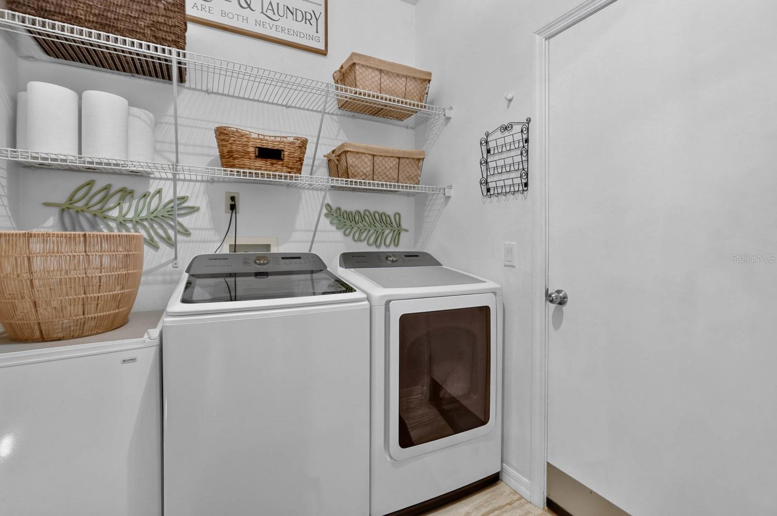 In home laundry room with shelving