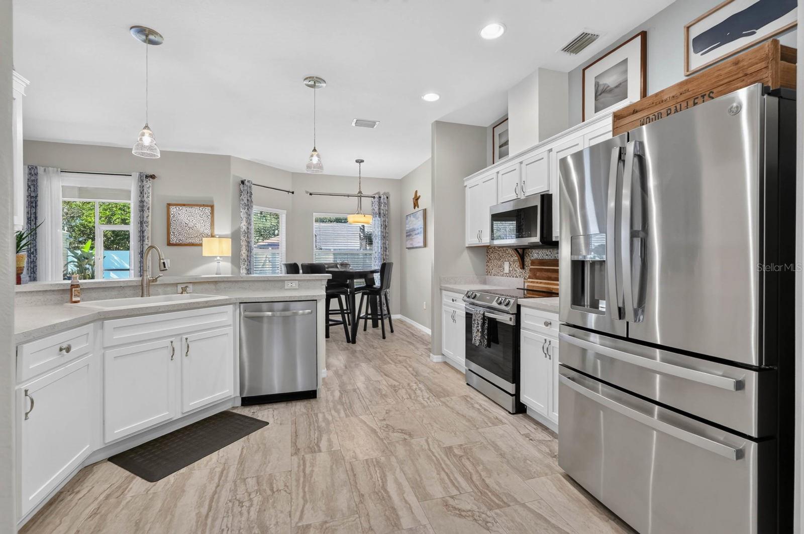 Open kitchen with new stainless steel appliances