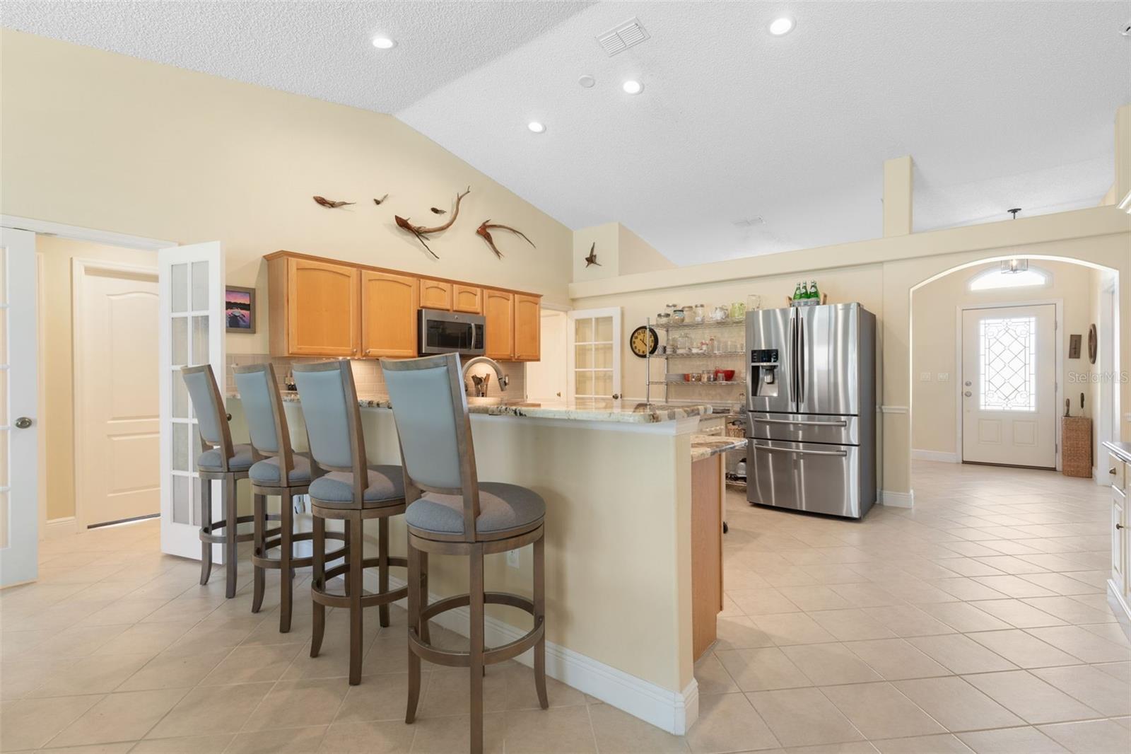 The extended granite breakfast bar offers seating for four, creating a stylish alternative to traditional dining with plenty of counter space for everything from a leisurely brunch to an evening appetizer spread.