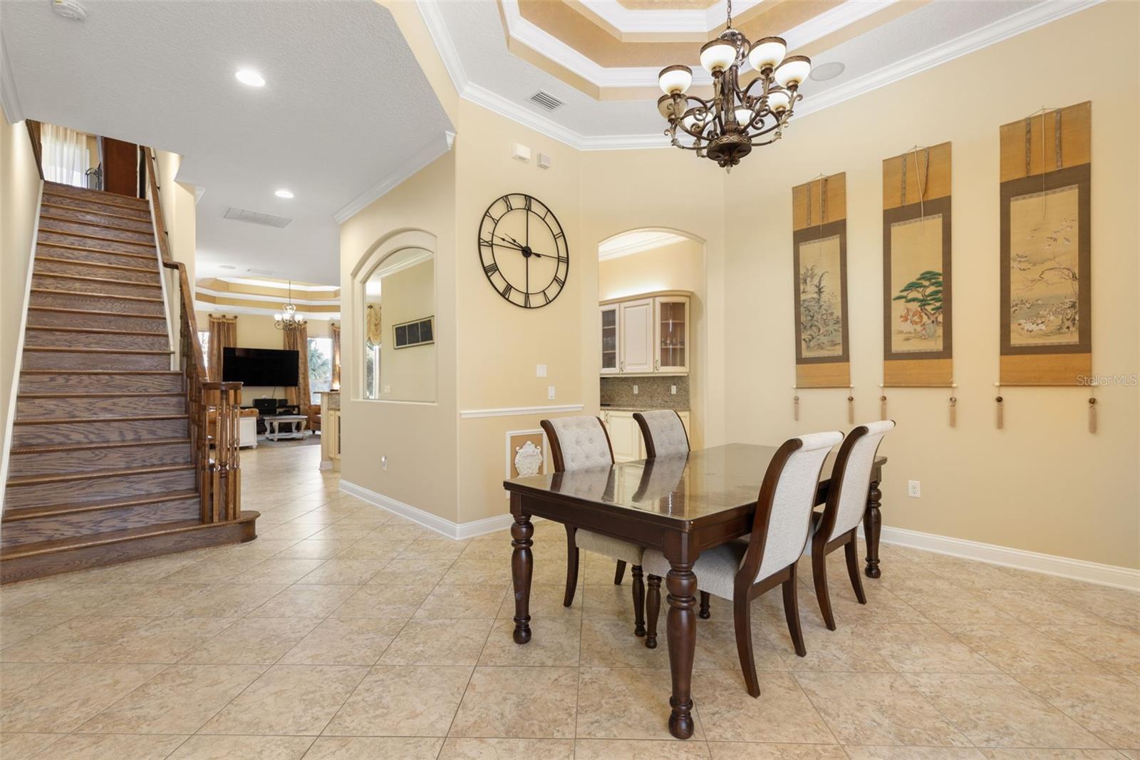 A beautifully appointed dining room with an elegant tray ceiling, decorative chandelier and architectural details that create a memorable setting for gatherings.