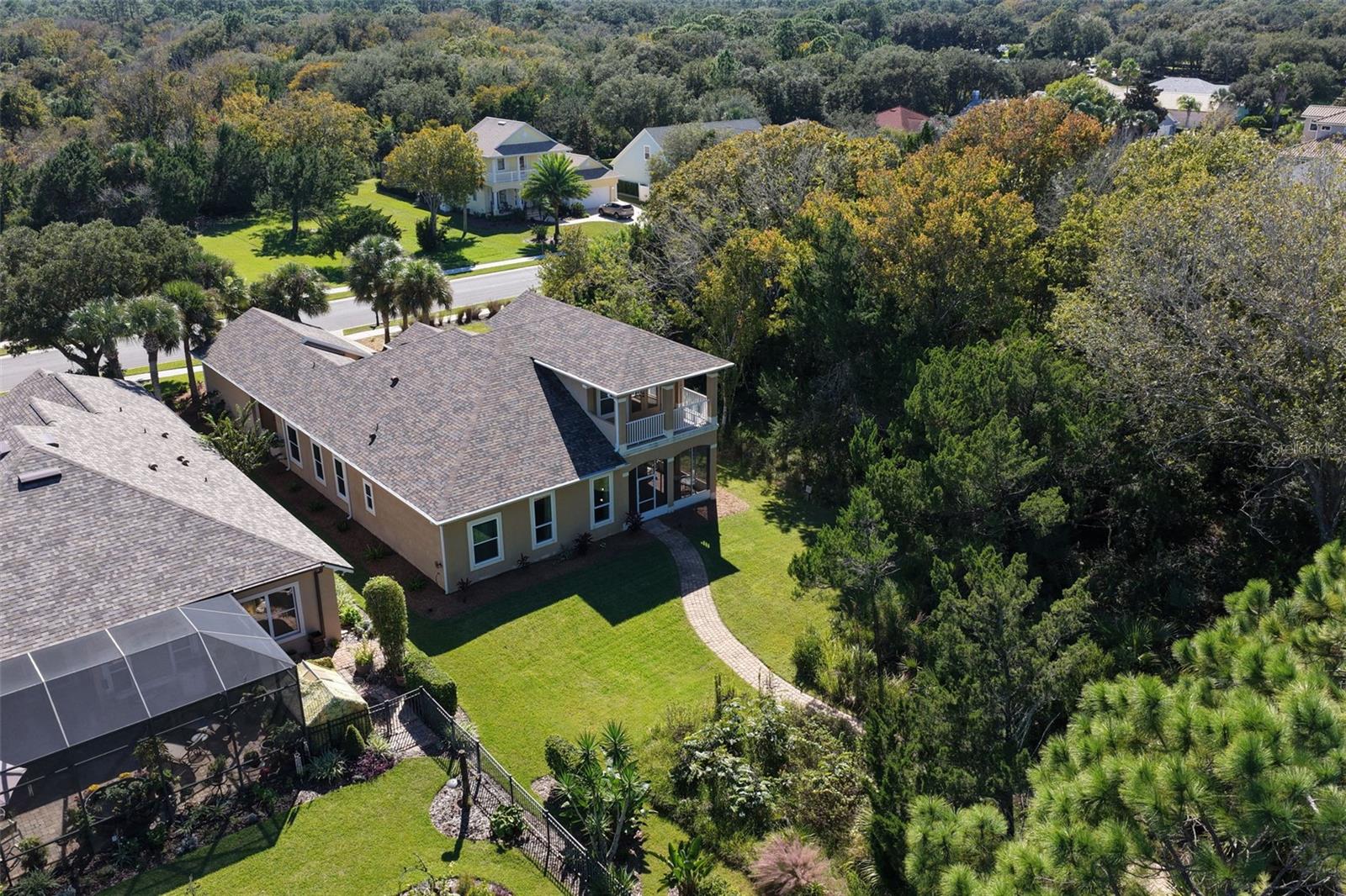 A spacious backyard surrounded by natural greenery, offering privacy and a peaceful setting to enjoy the outdoors.