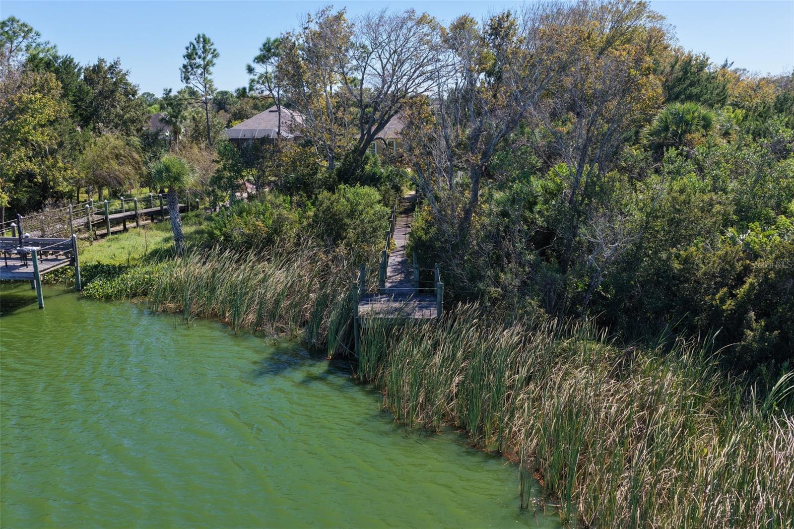 A private walkway winds through the natural landscape to a lakeside dock overlooking Emerald Lake.