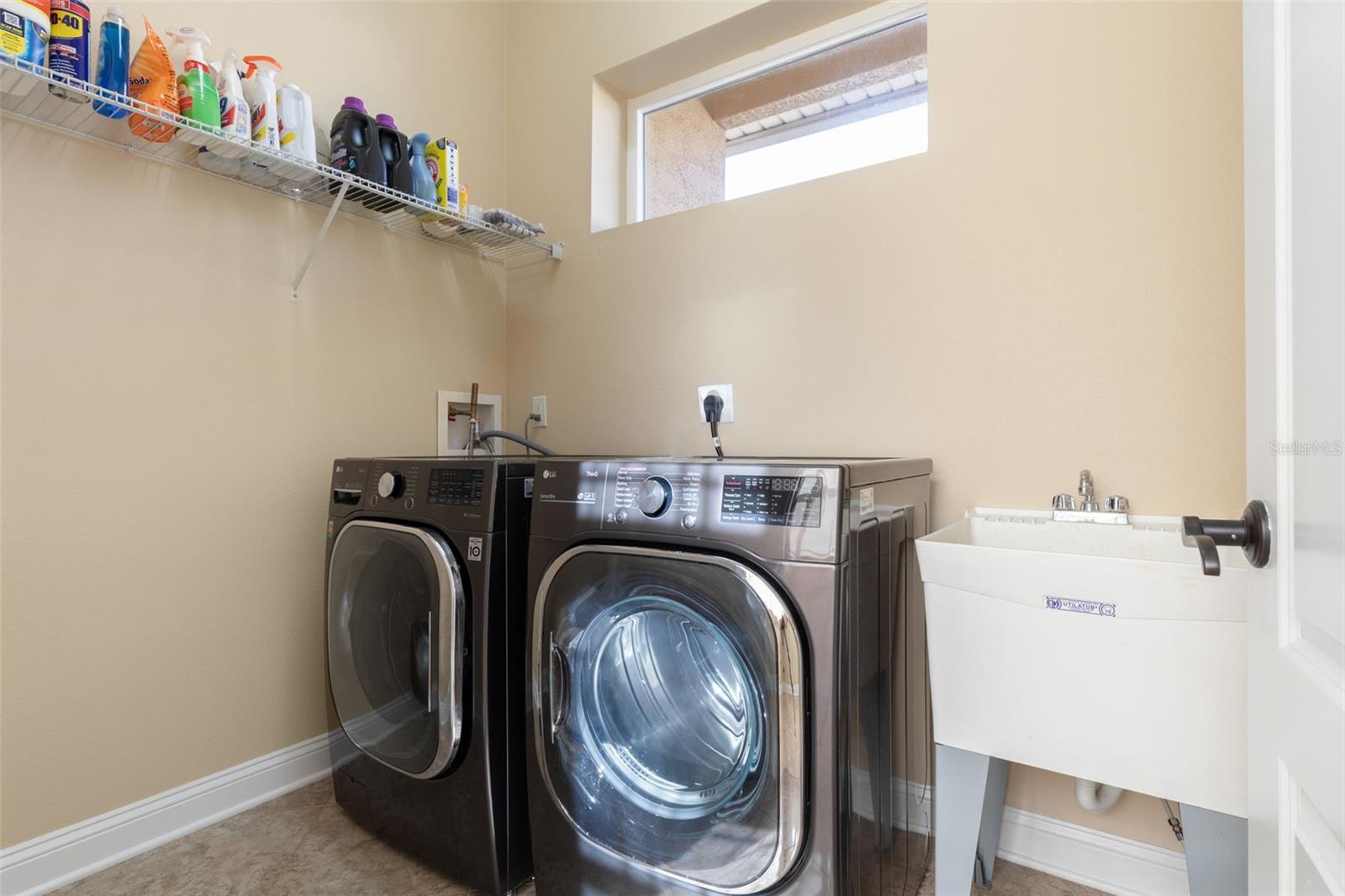 Convenient Indoor Laundry Room with Washer, Dryer & Utility Sink