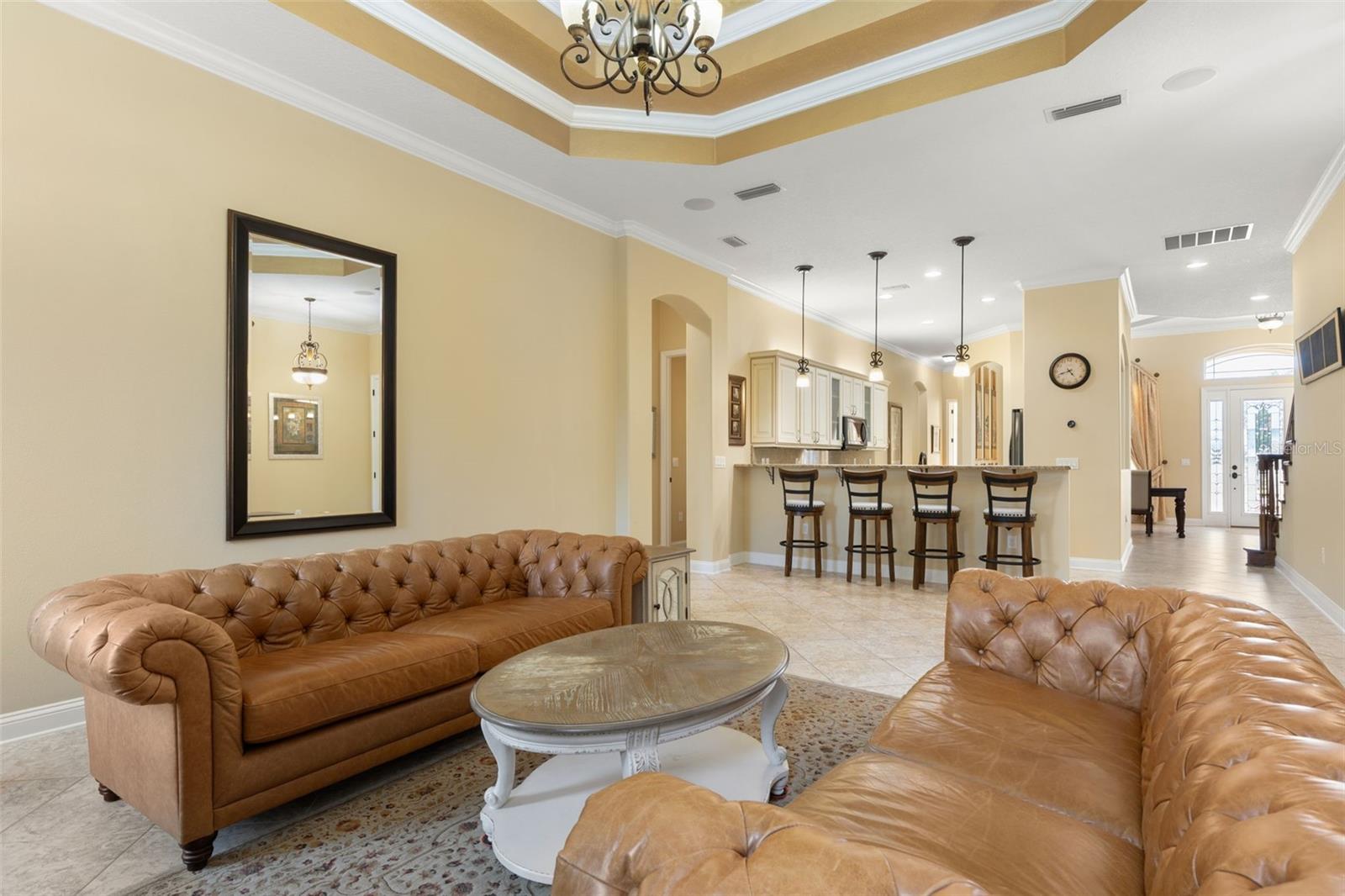 An open, welcoming layout offers a view toward the home's front entrance, showcasing the thoughtful connection between living spaces.