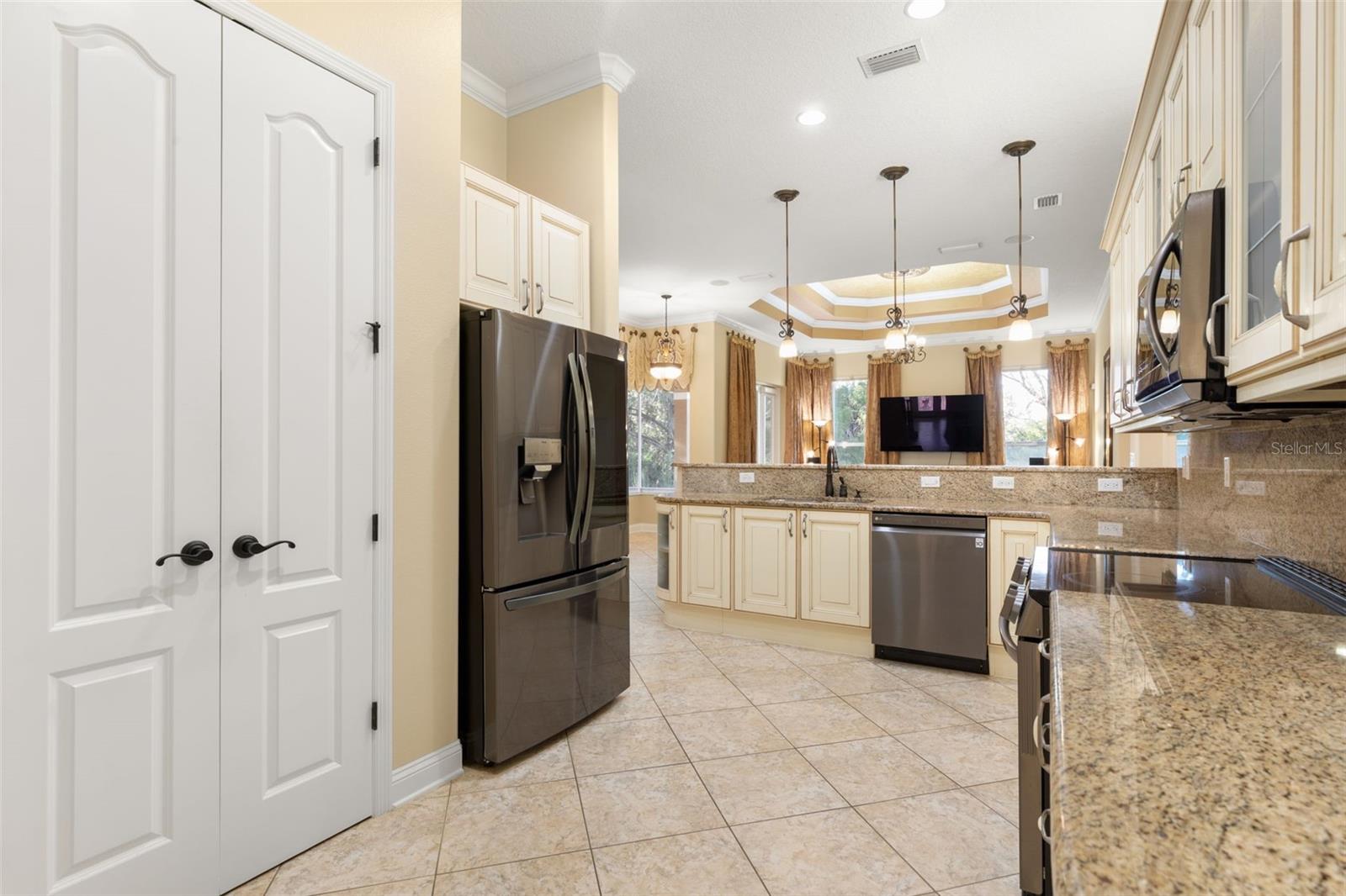Italian-inspired cabinetry, granite countertops and backsplash bring timeless elegance to this thoughtfully designed kitchen.
