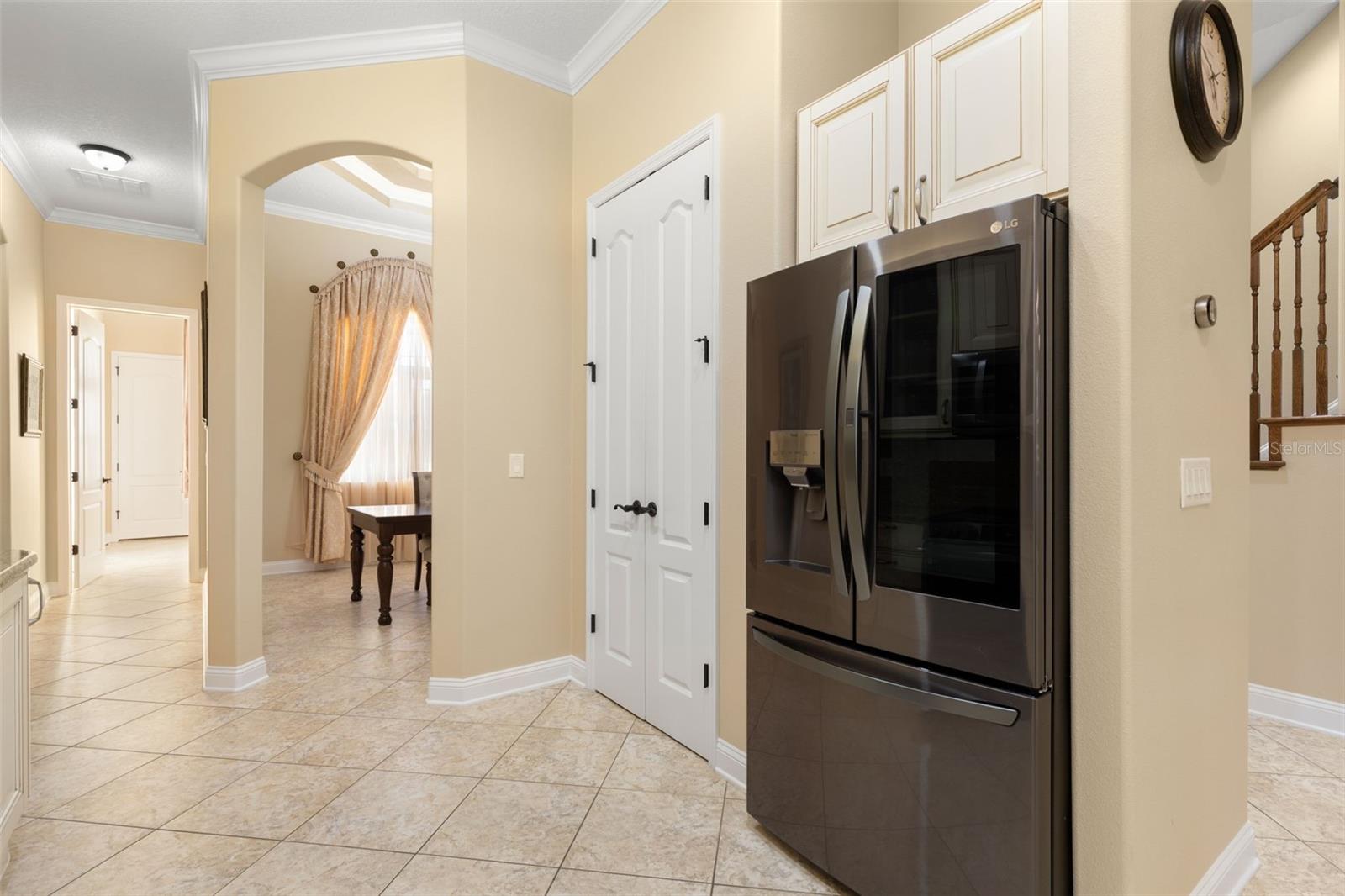 Thoughtfully designed for everyday convenience, the kitchen connects easily to the adjoining dining area.