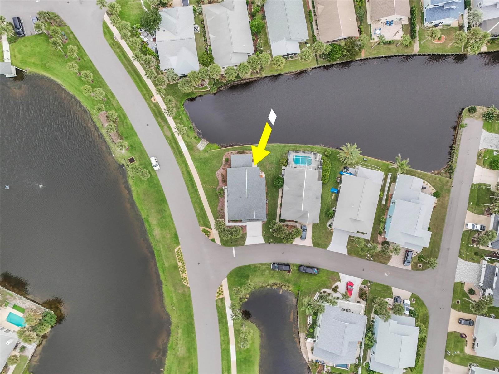View of lake across the street and canal in front canal in back steps to ocean