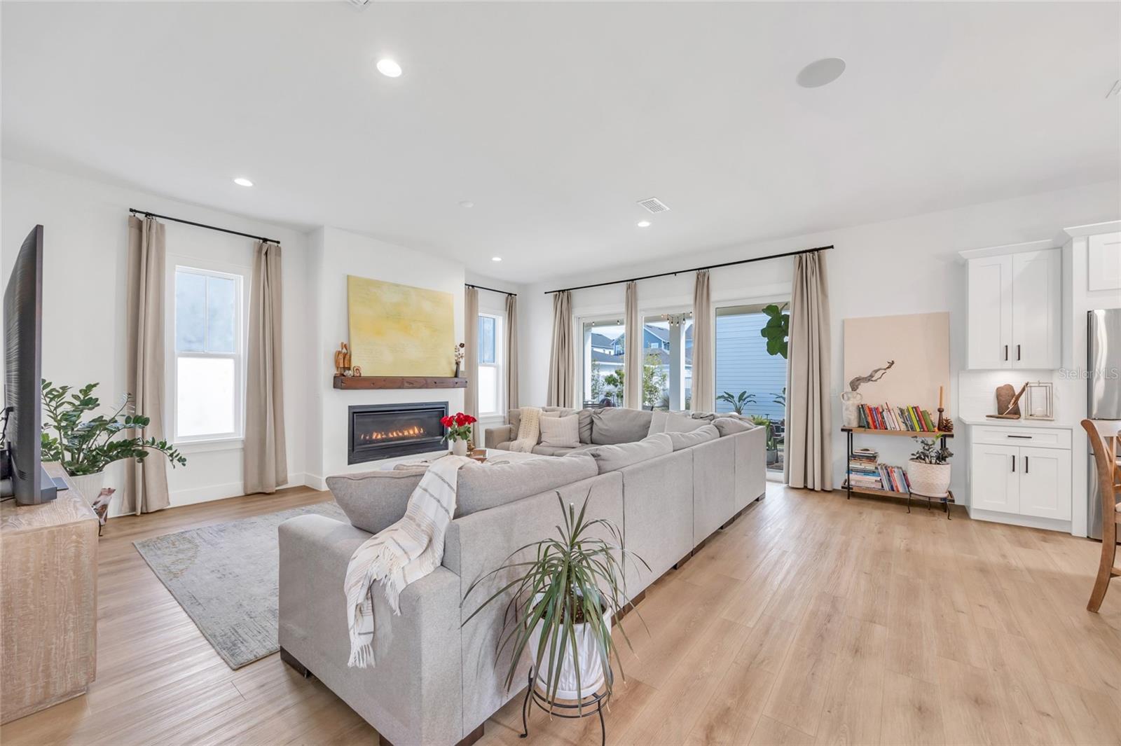 Inviting open concept living room centered around beautiful gas fireplace, perfect for every day living