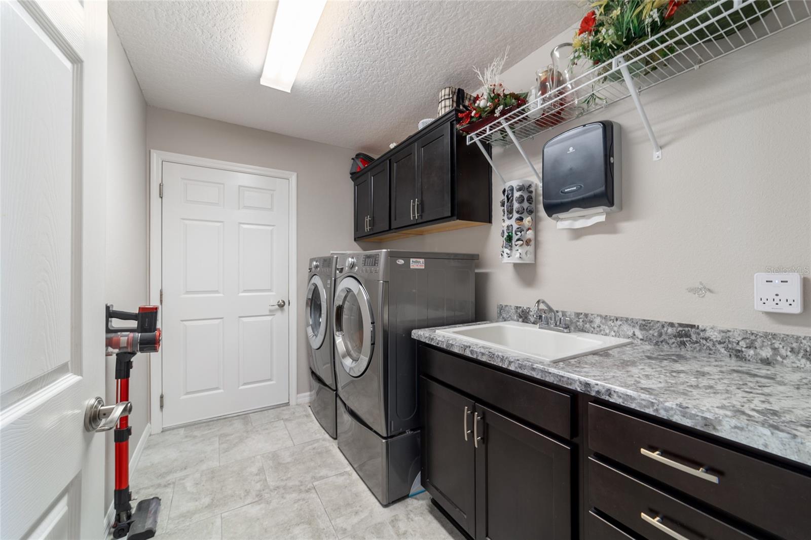 Interior laundry with sink and cabinets