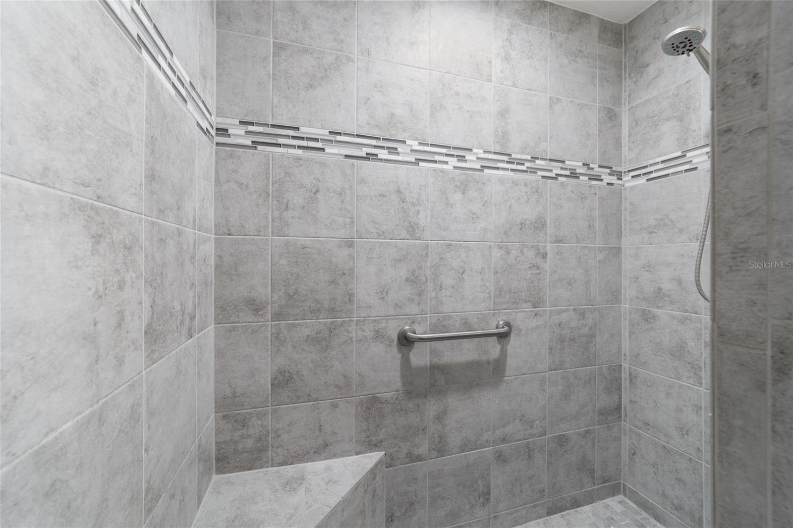 Tiled Roman shower in the primary bath