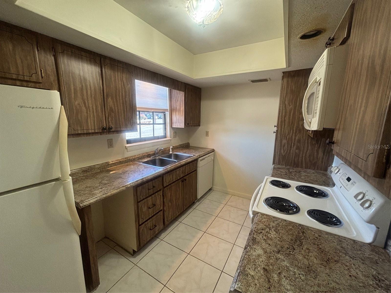 Kitchen includes Dishwasher, Refrigerator and microwace