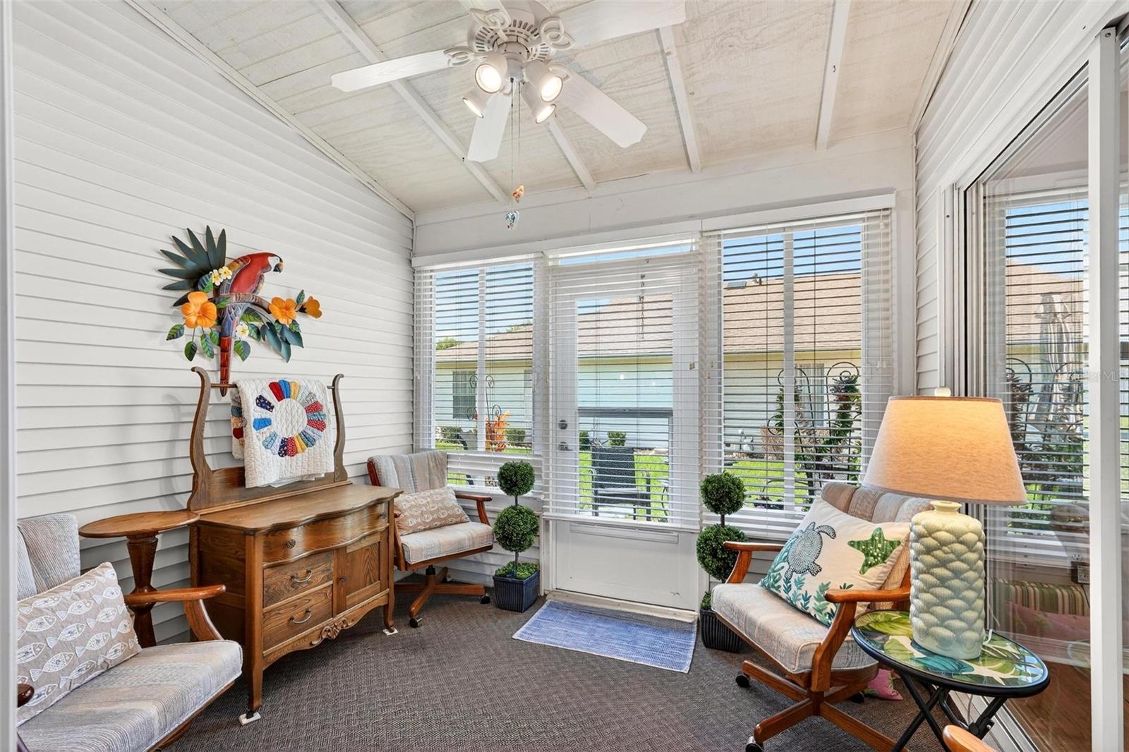 Florida room with ceiling fan and access from the living room and primary bedroom