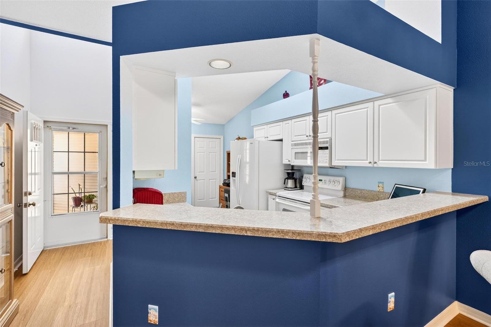 Breakfast bar featuring newer countertops