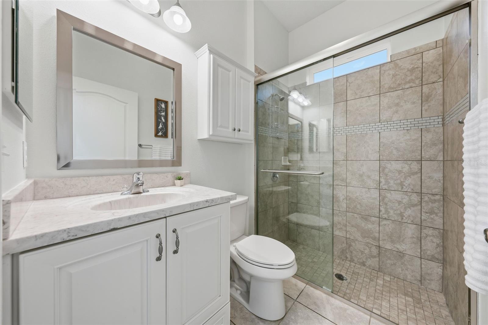 Bathroom 3 features tiled walk-in shower