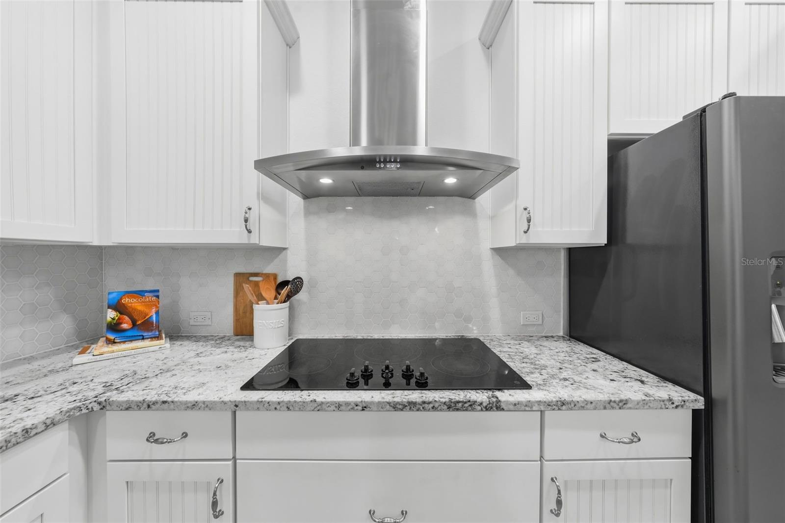 Glass cooktop with stainless steel hood