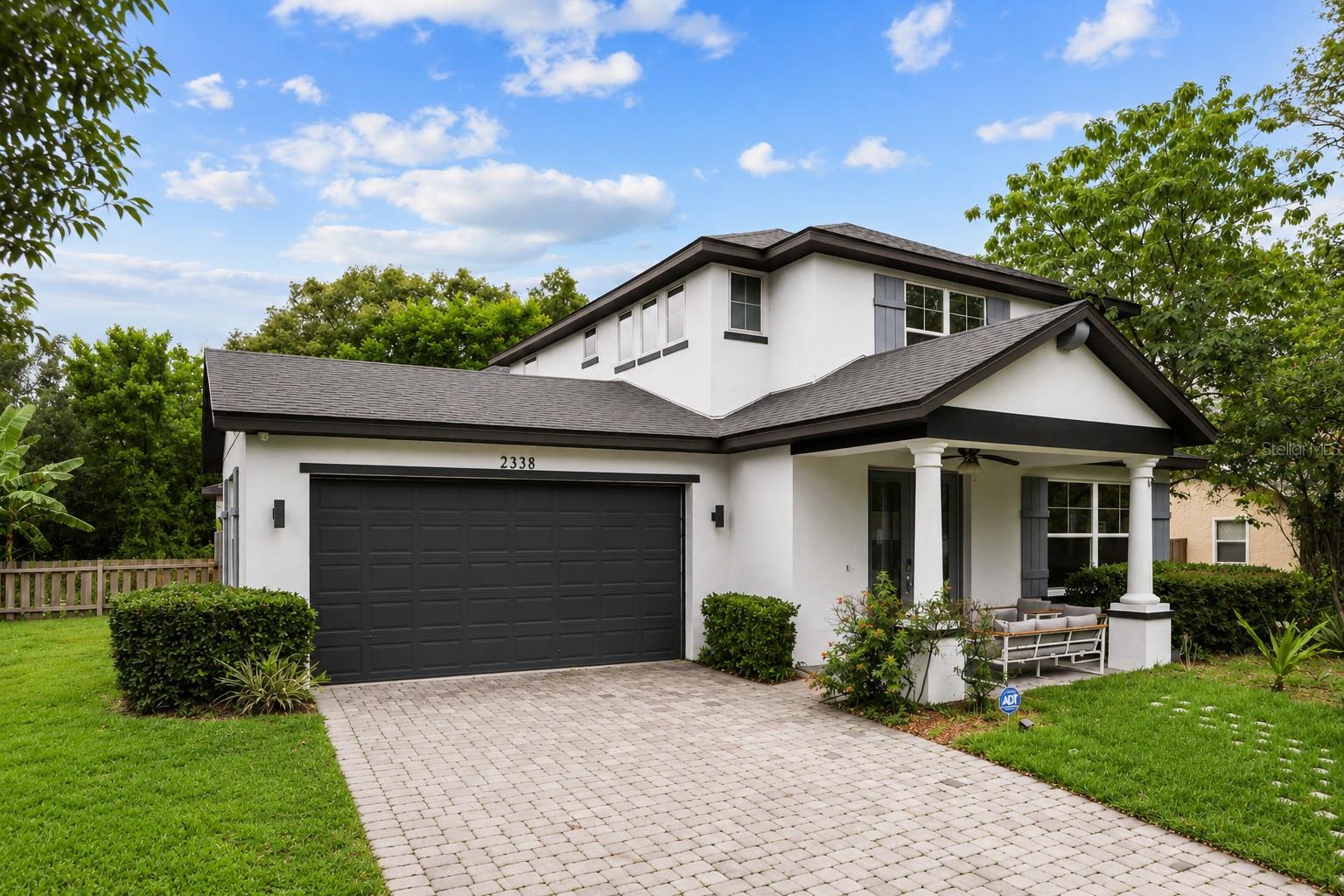 Attractive front exterior showcasing modern architecture,a paver driveway, covered front porch, and attached two-car garage. Attractive front exterior showcasing modern architecture,a paver driveway, covered front porch, and attached two-car garage.