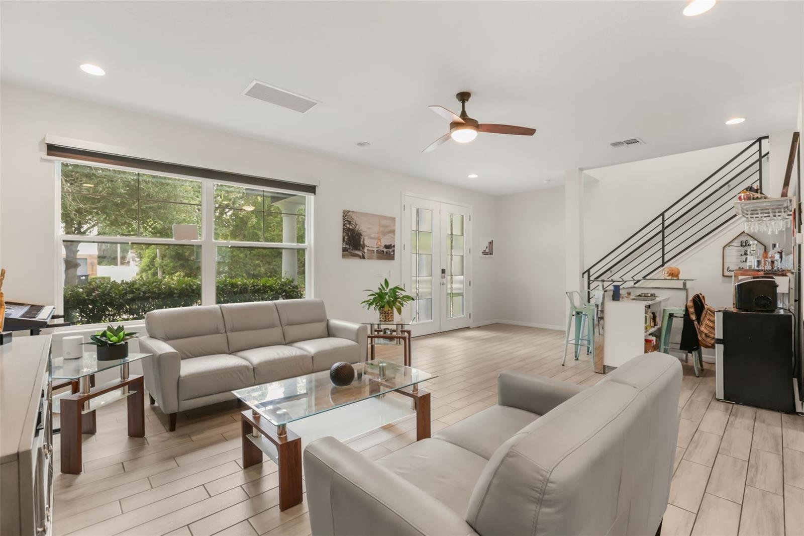 Inviting living room with abundant natural light, high ceilings, and an open layout that creates a bright and welcoming atmosphere. Inviting living room with abundant natural light, high ceilings, and an open layout that creates a bright and welcoming atmosphere.