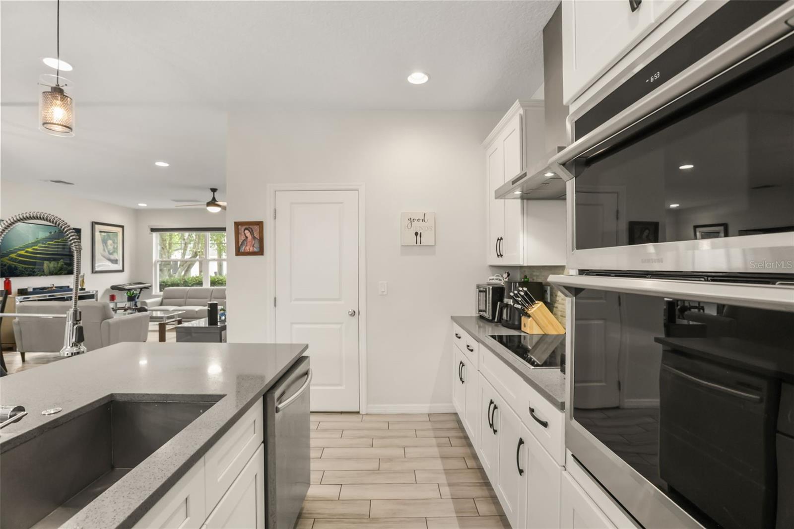 Well-appointed kitchen featuring built-in oven and microwave, solid surface countertops, abundant cabinetry, and a functional layout for everyday living. Well-appointed kitchen featuring built-in oven and microwave, solid surface countertops, abundant cabinetry, and a functional layout for everyday living.