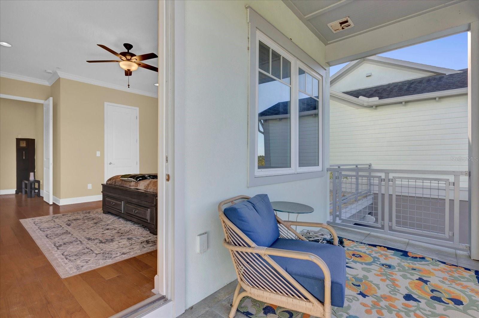 Private covered balcony off the primary suite  a peaceful spot to unwind.