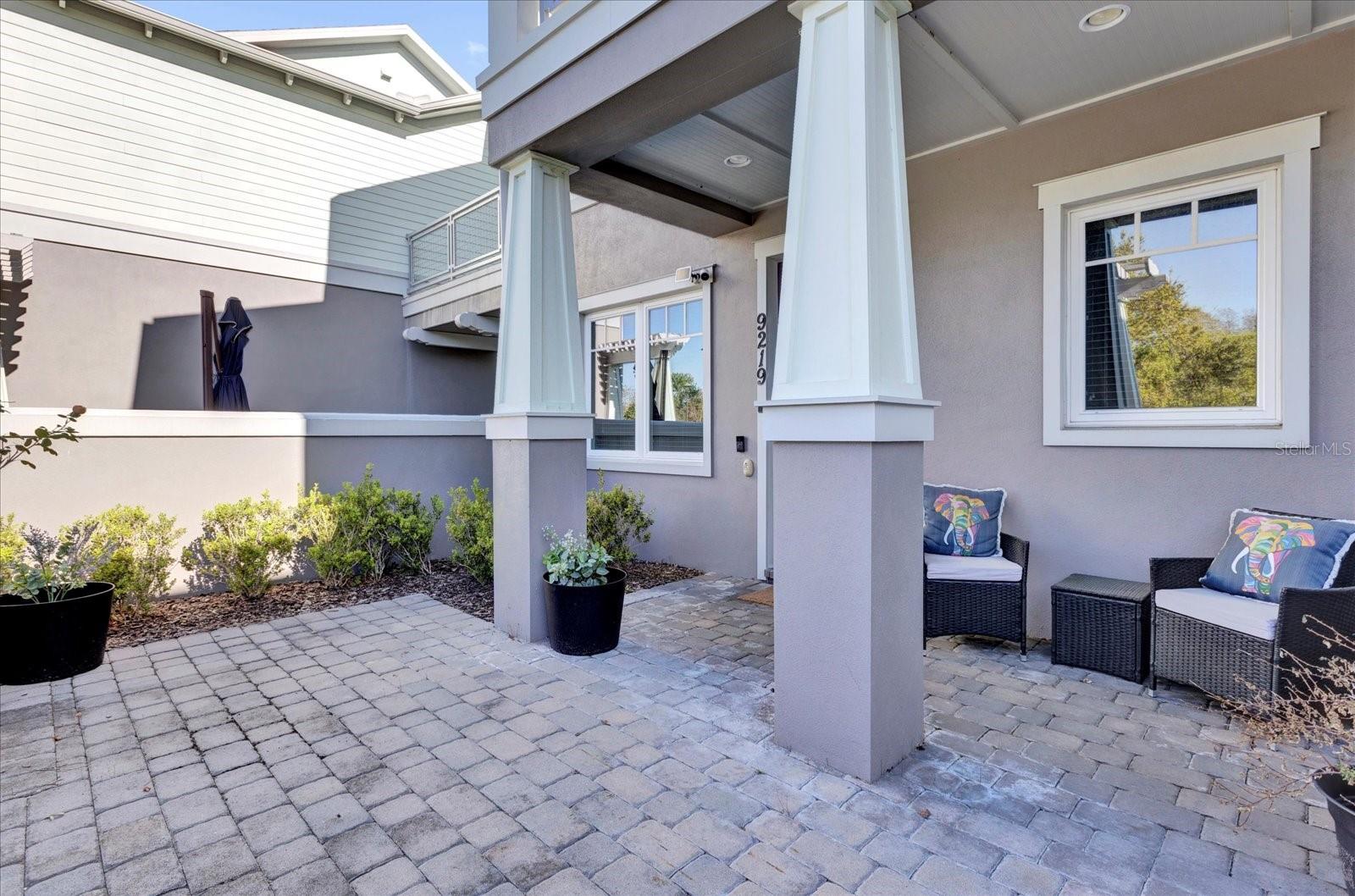 Private covered patio with paver flooring  the perfect low-maintenance outdoor retreat.